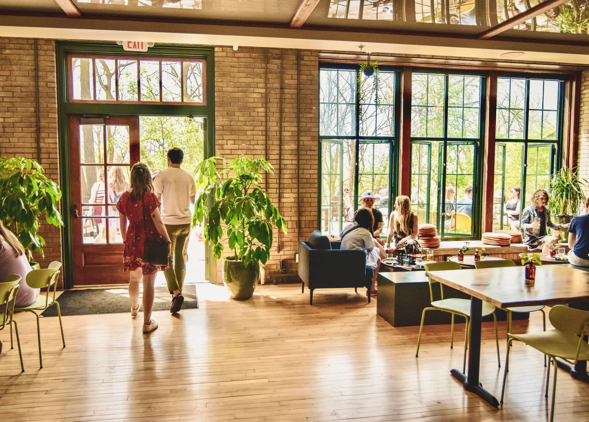 Commons dining room with brick walls and big windows at Understory