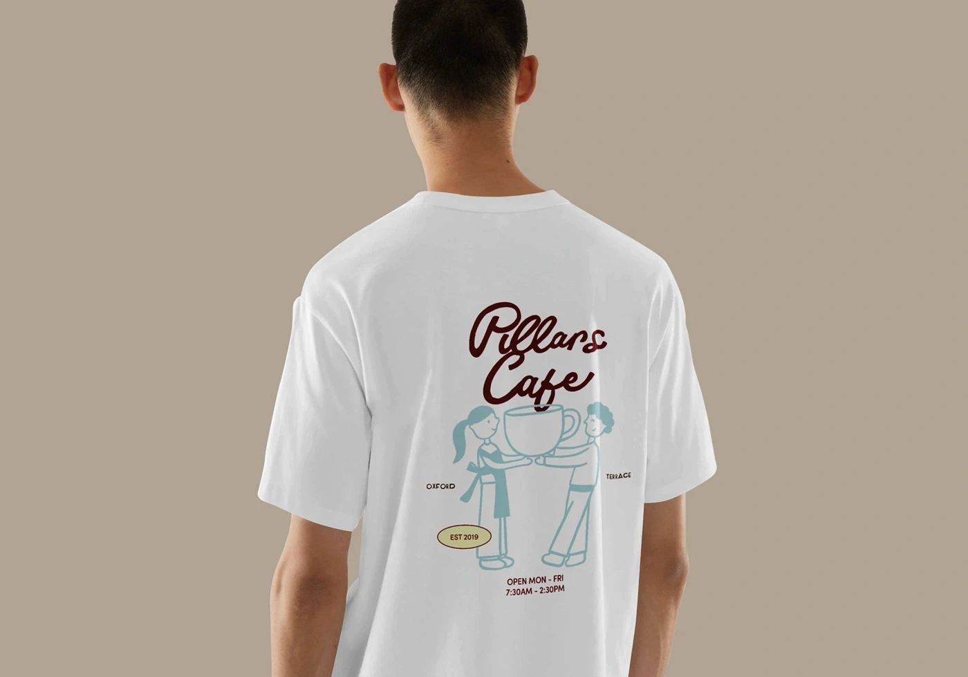 Back view of a white T-shirt printed with the Pillars Cafe coffee-cup illustration.