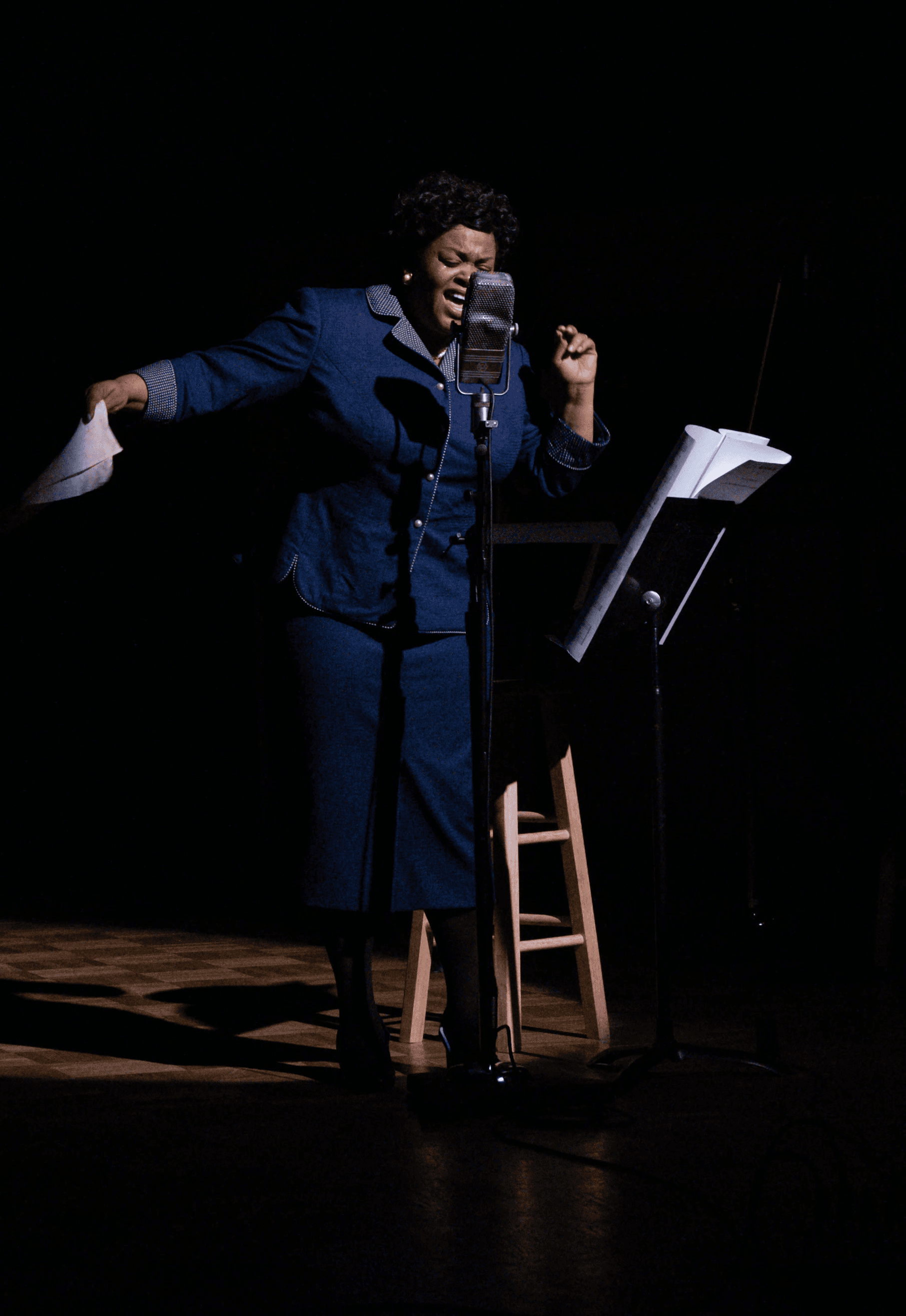 an empty theater with a large screen on the wall
