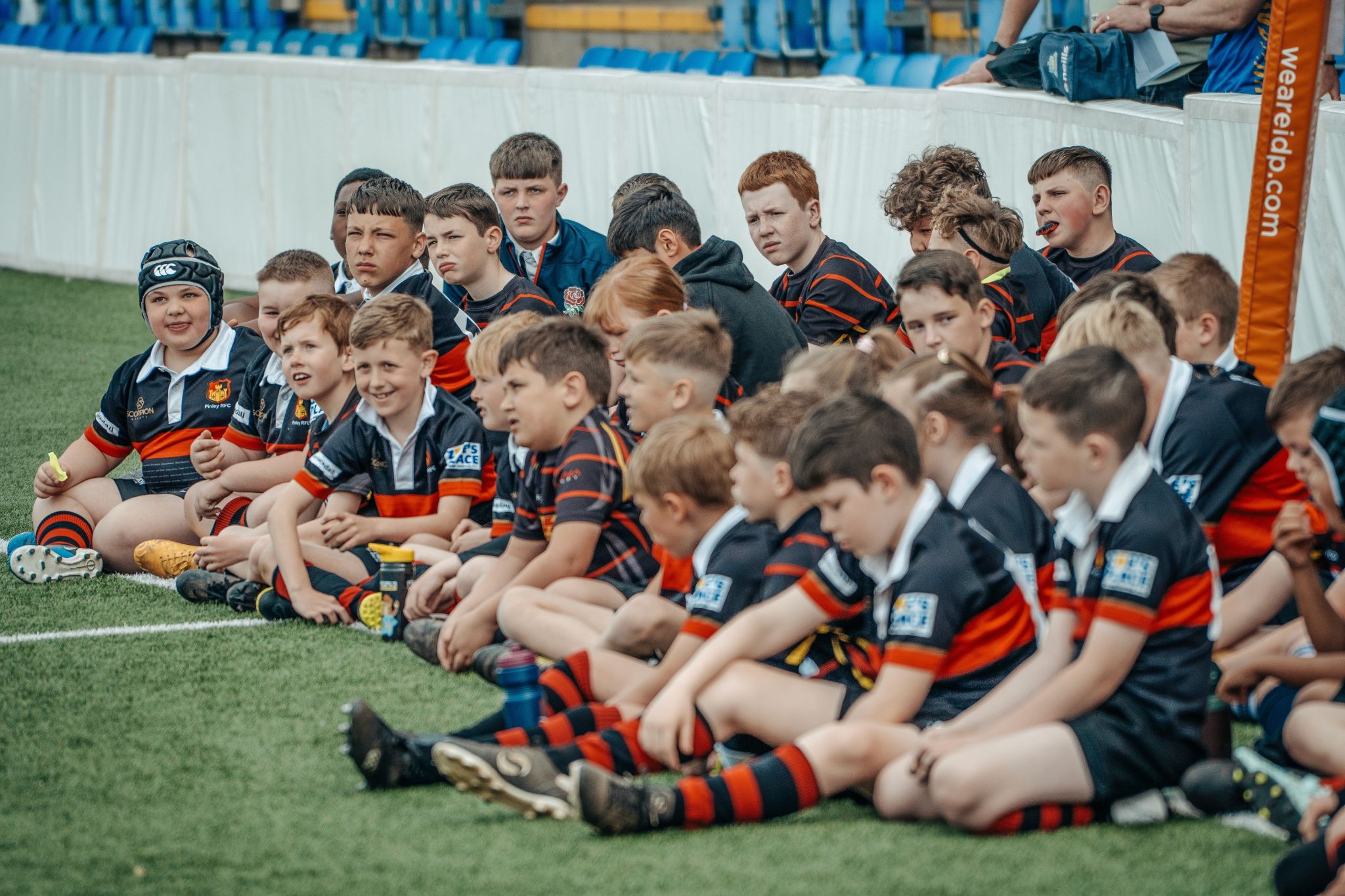 A man holding a rugby ball on a field