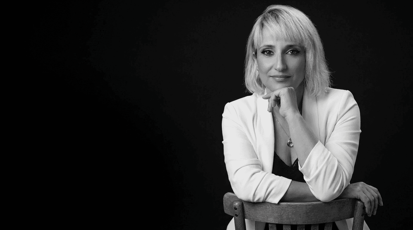 Rachel, personal trainer, looking to the side confidently in a fitness studio