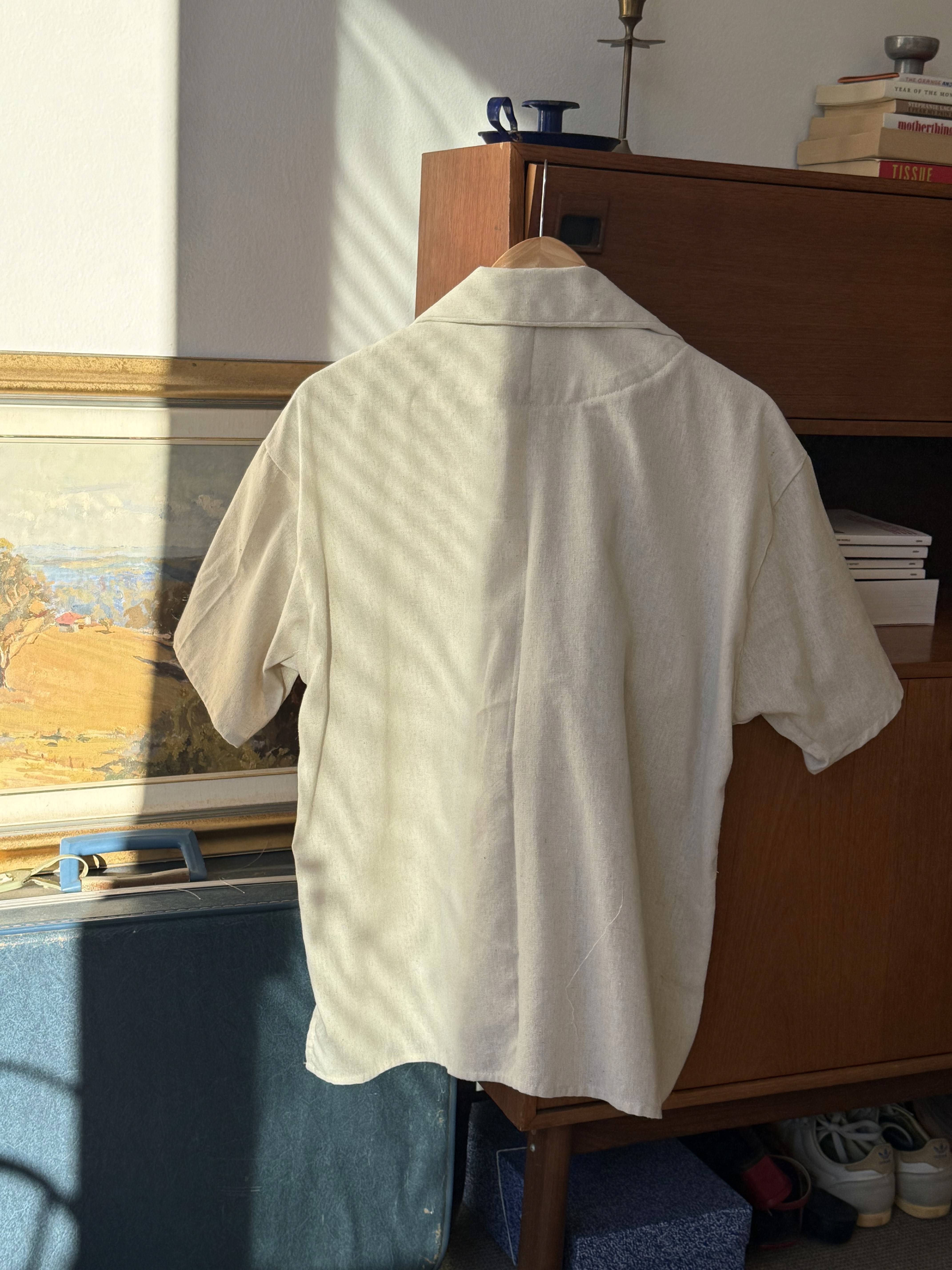 Back of off-white button down t-shirt 