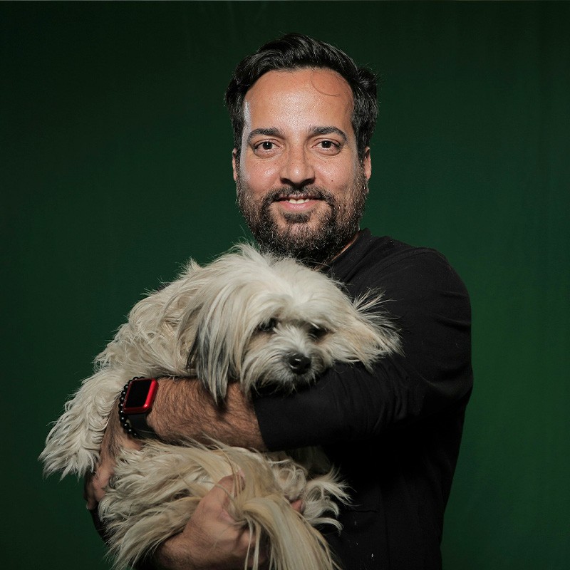 A man with a dog on his lap.