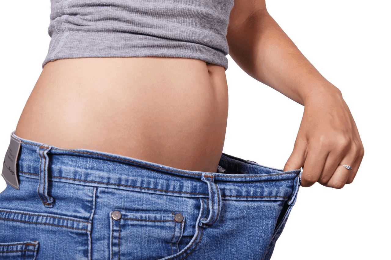Loose jeans after weight loss, highlighting changes in body composition and muscle mass