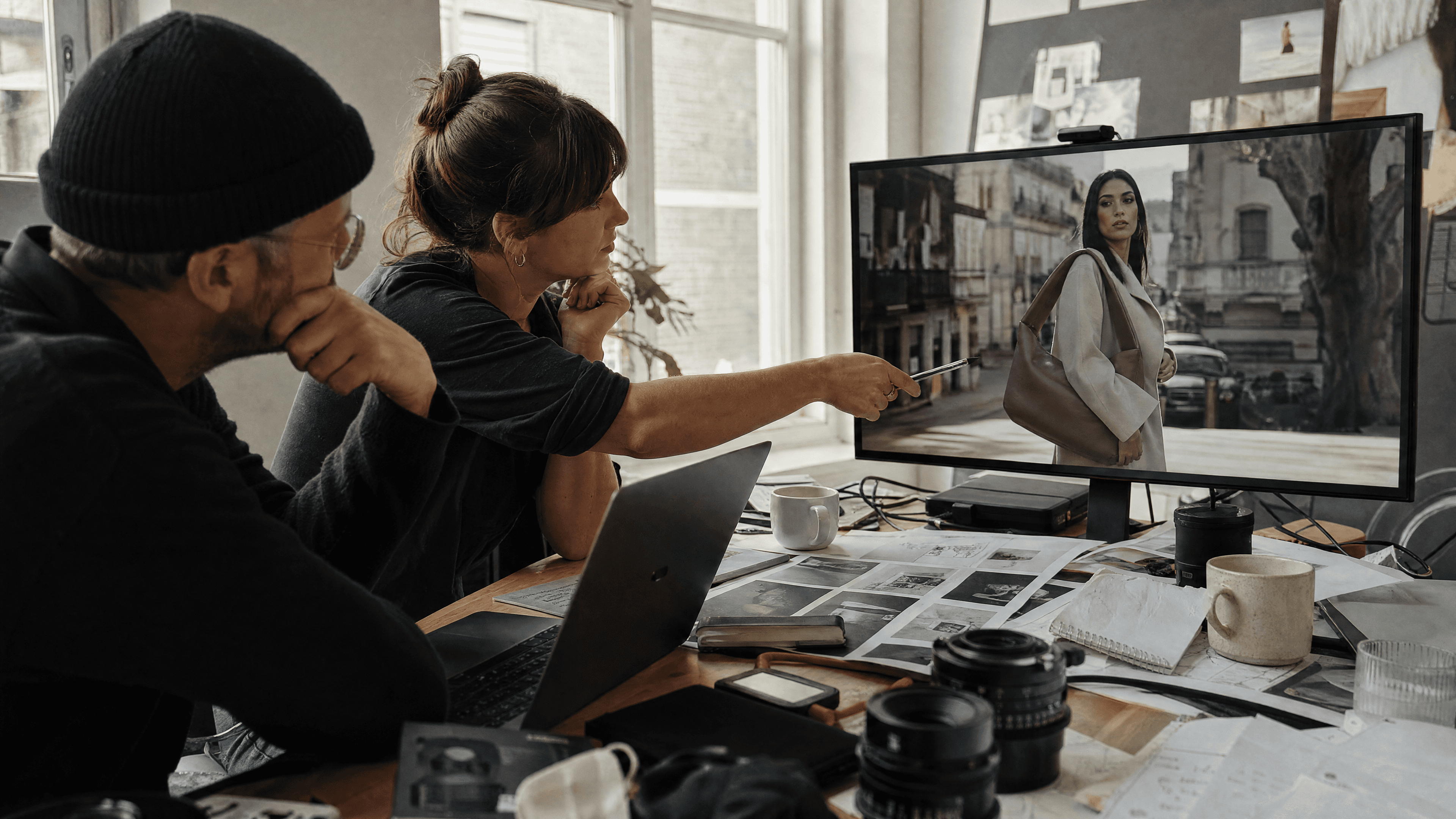 Director and producer reviewing an AI-generated product launch video in a bright studio