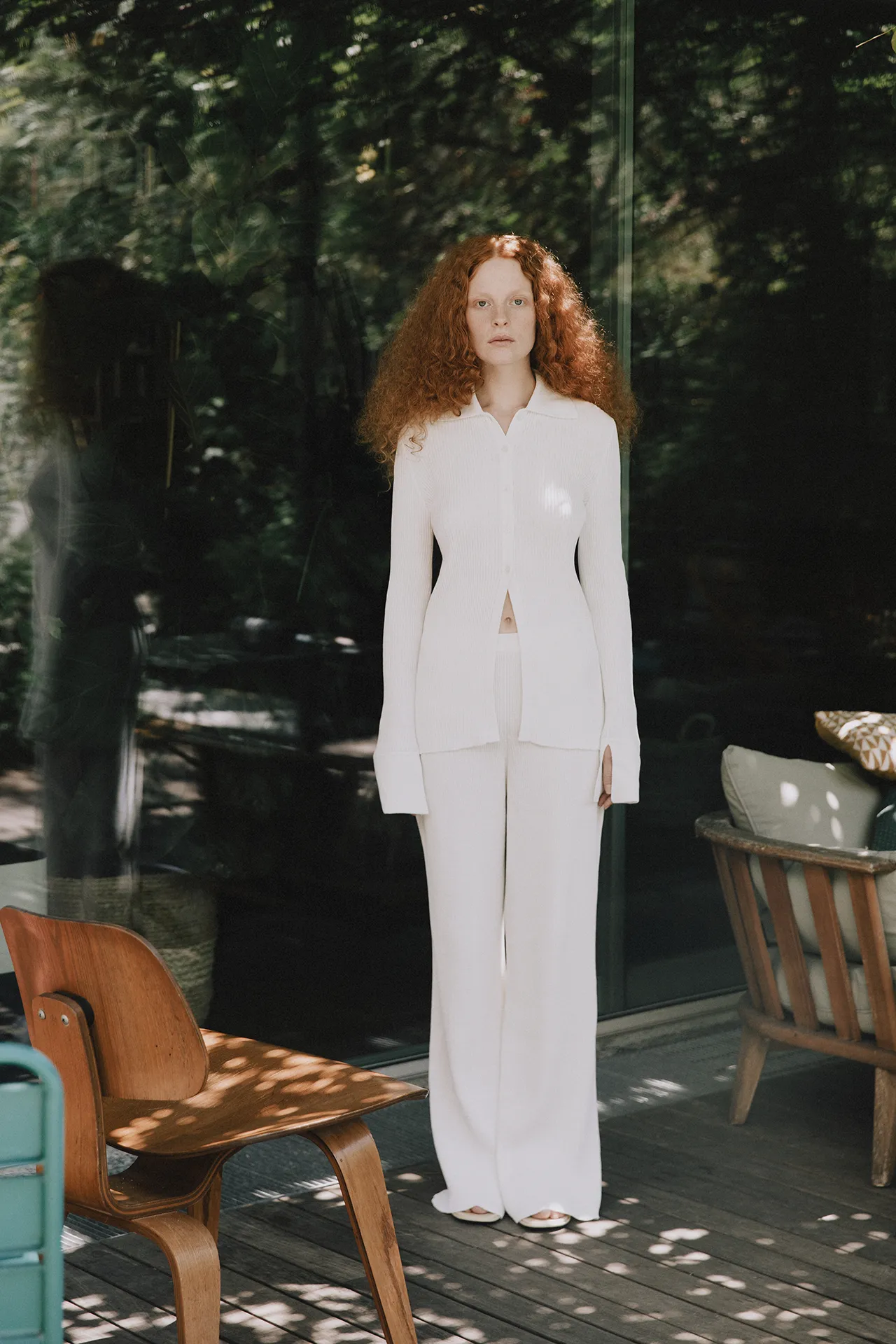 Annapurna SS26 collection white fitted ribbed knit button-down cardigan and matching wide-leg trousers.