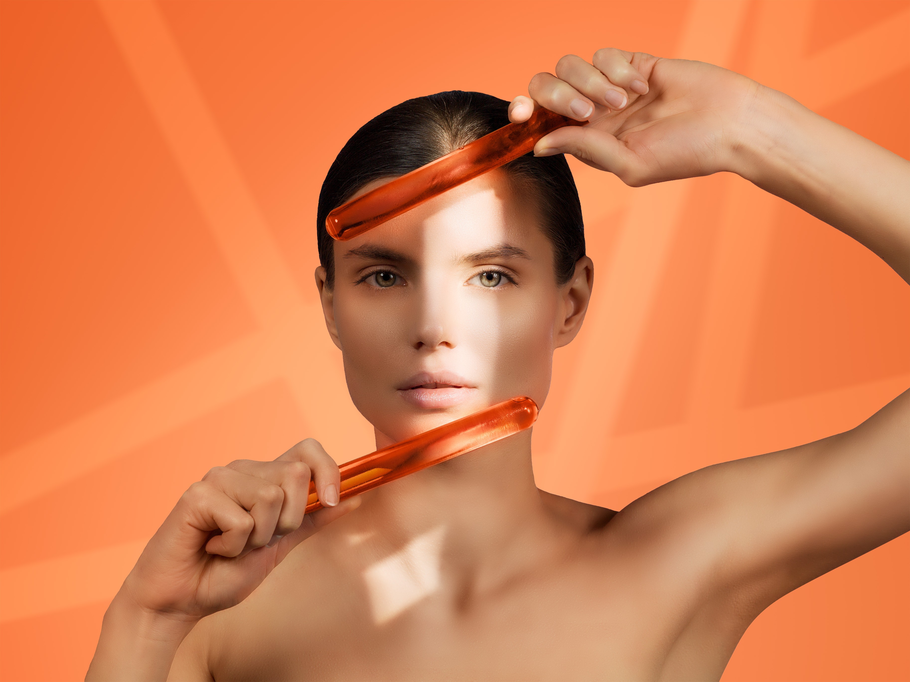 Croma Saypha Volume Lidocaine dermal filler product model Canada posing with orange glass sticks on orange background