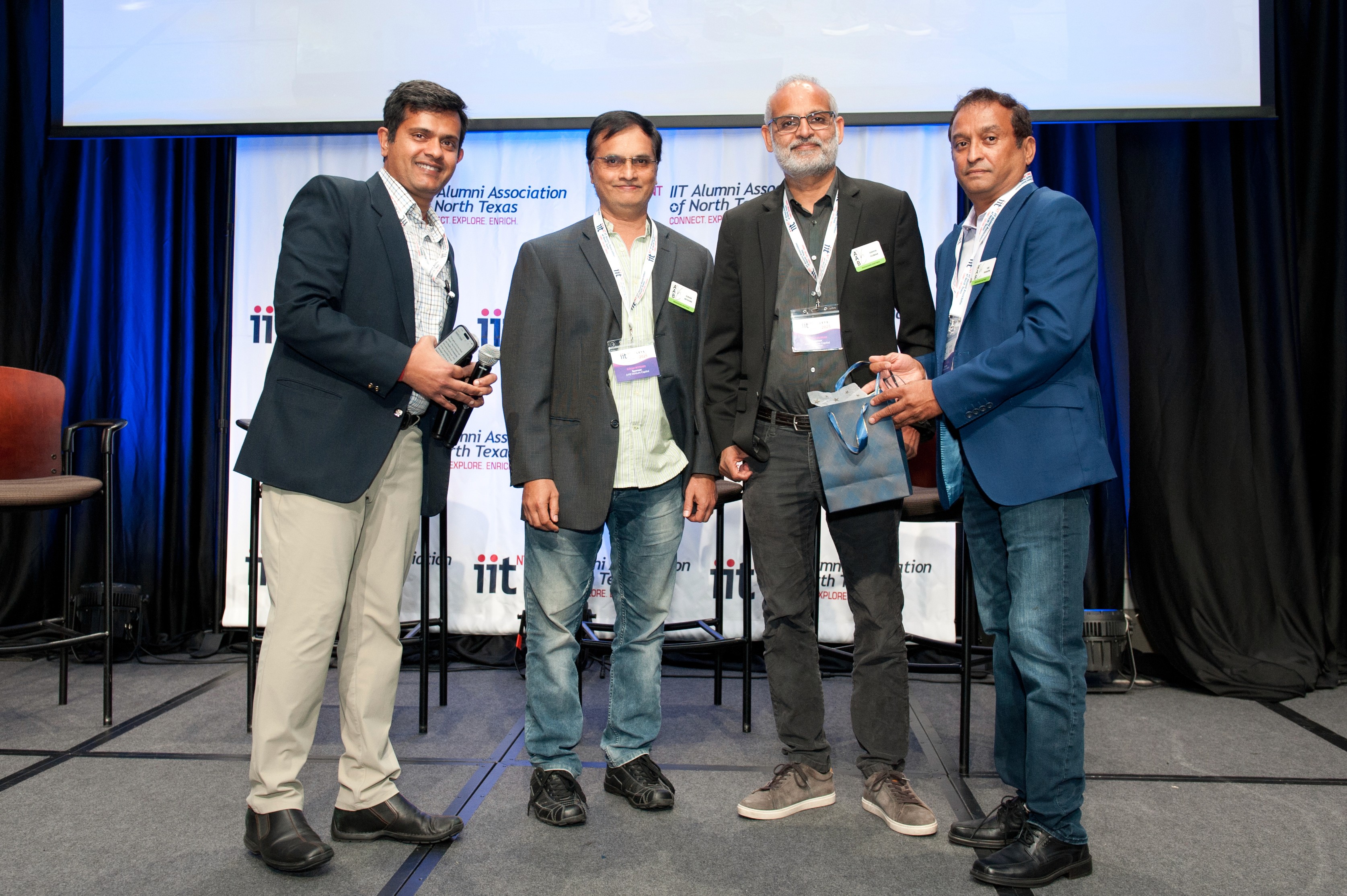 Close-up of a sleek dark green SUV with modern design elements, illuminated against a dark green background.