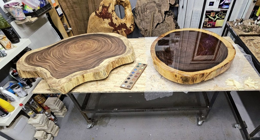a group of people sitting at a table with a fire in the background