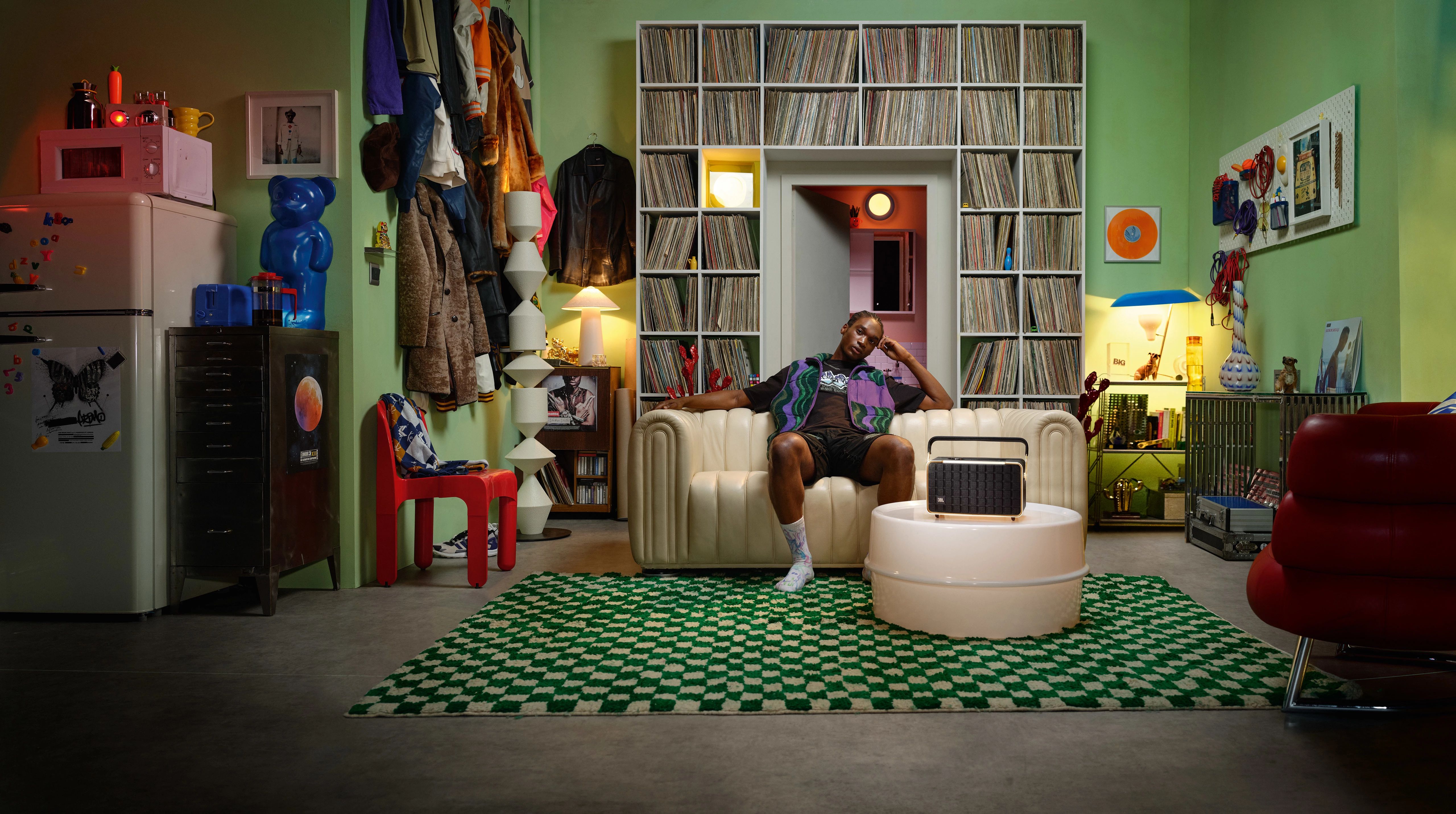 The JBL Authentics speaker at home, in a record-lined living room.