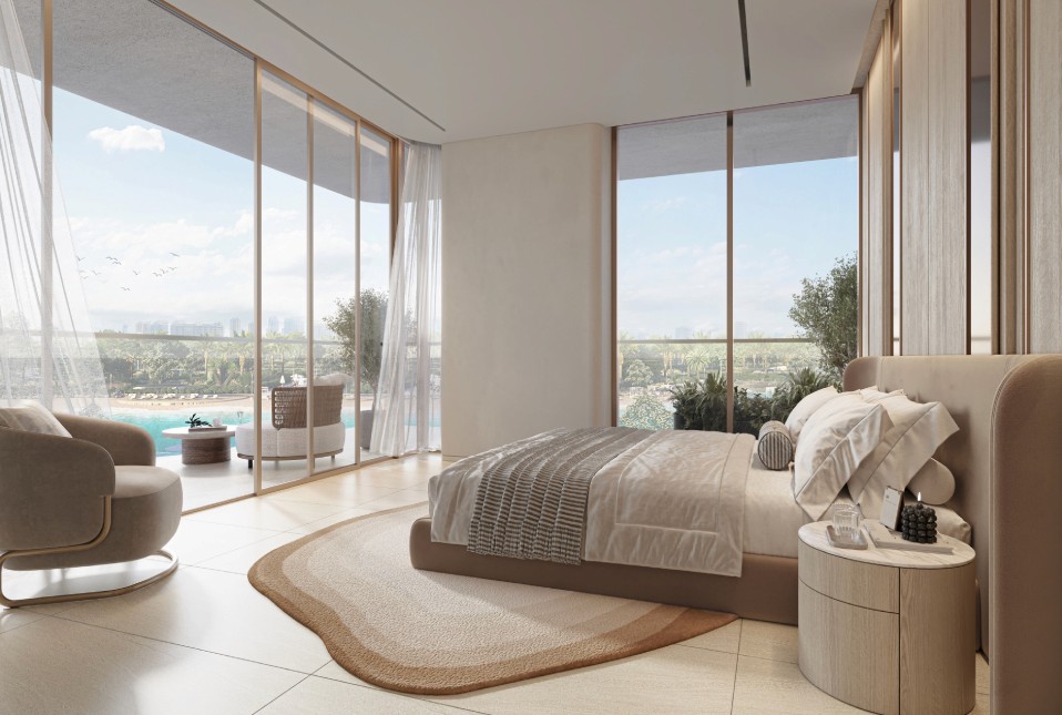 A cozy bedroom showcasing a stunning water view through a large window, part of The Caden by Prescott.