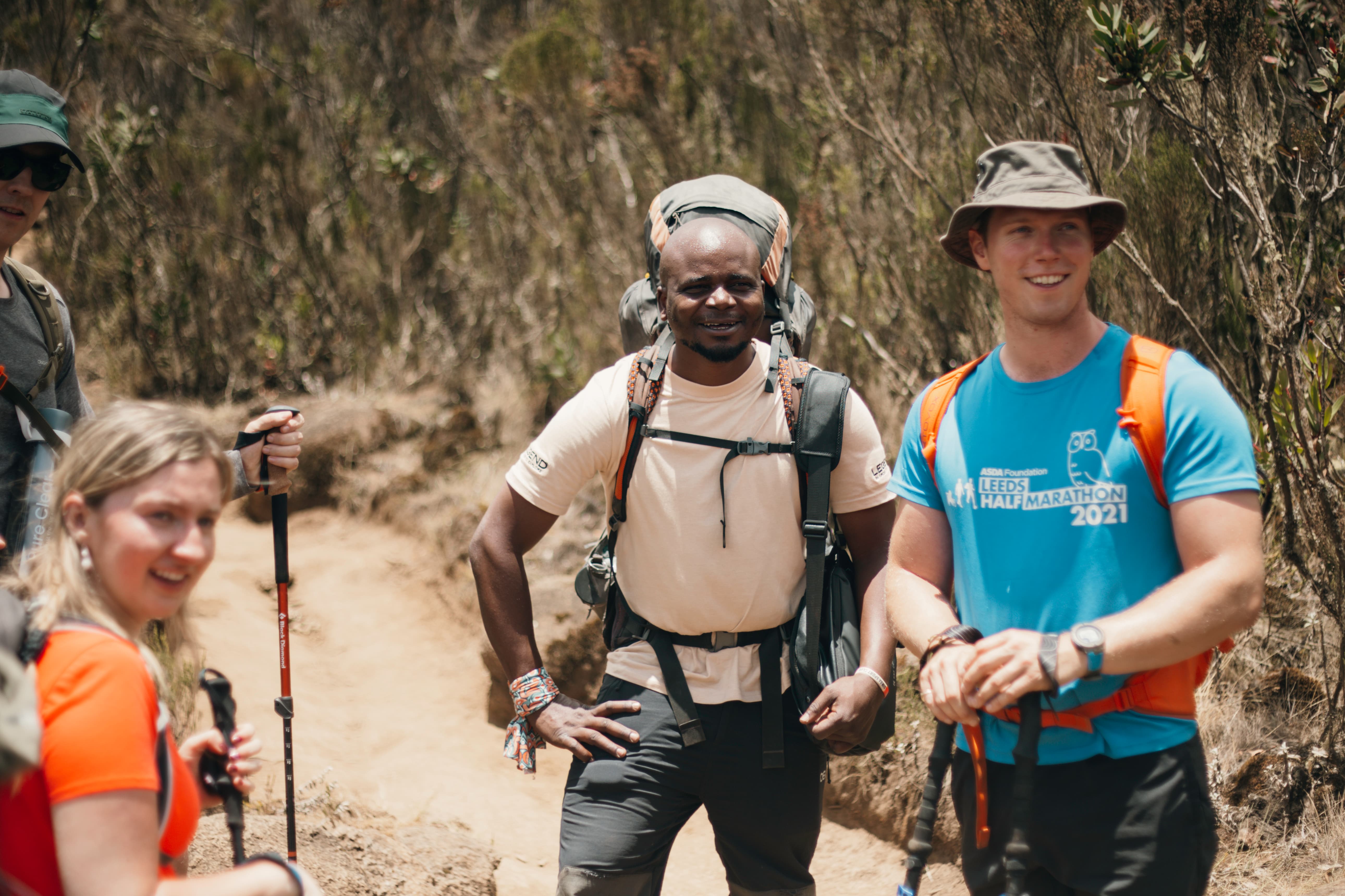 Legend Expeditions climbers walking through the moorland zone on Kilimanjaro in clear weather during the dry season.