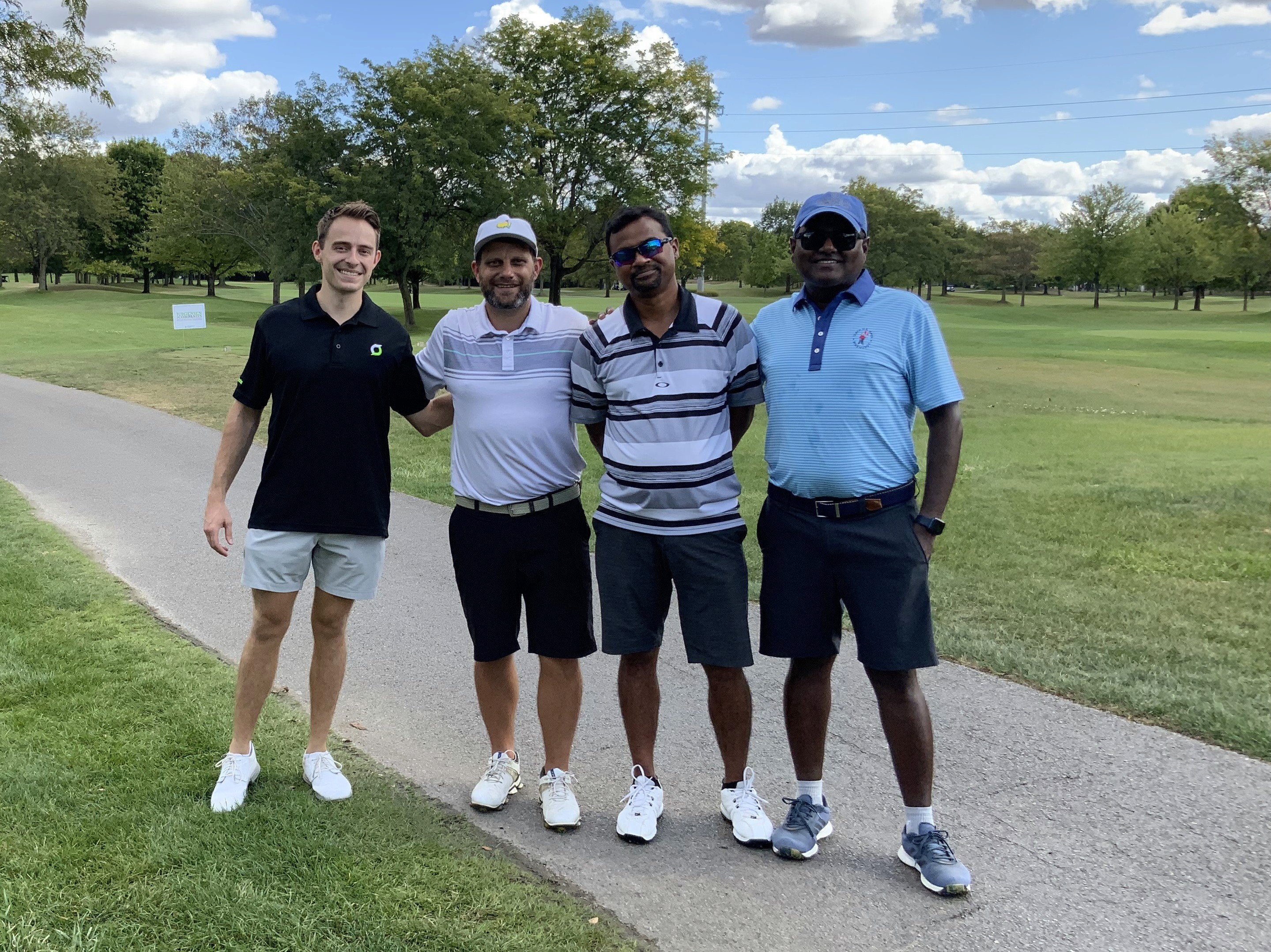 Smart Data Employees at a golf course having fun golfing 