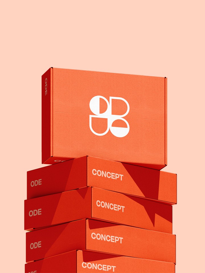 Single red-orange box bearing a white ODE logo balanced atop a neat stack of flat “CONCEPT” boxes, all on a pale peach surface.
