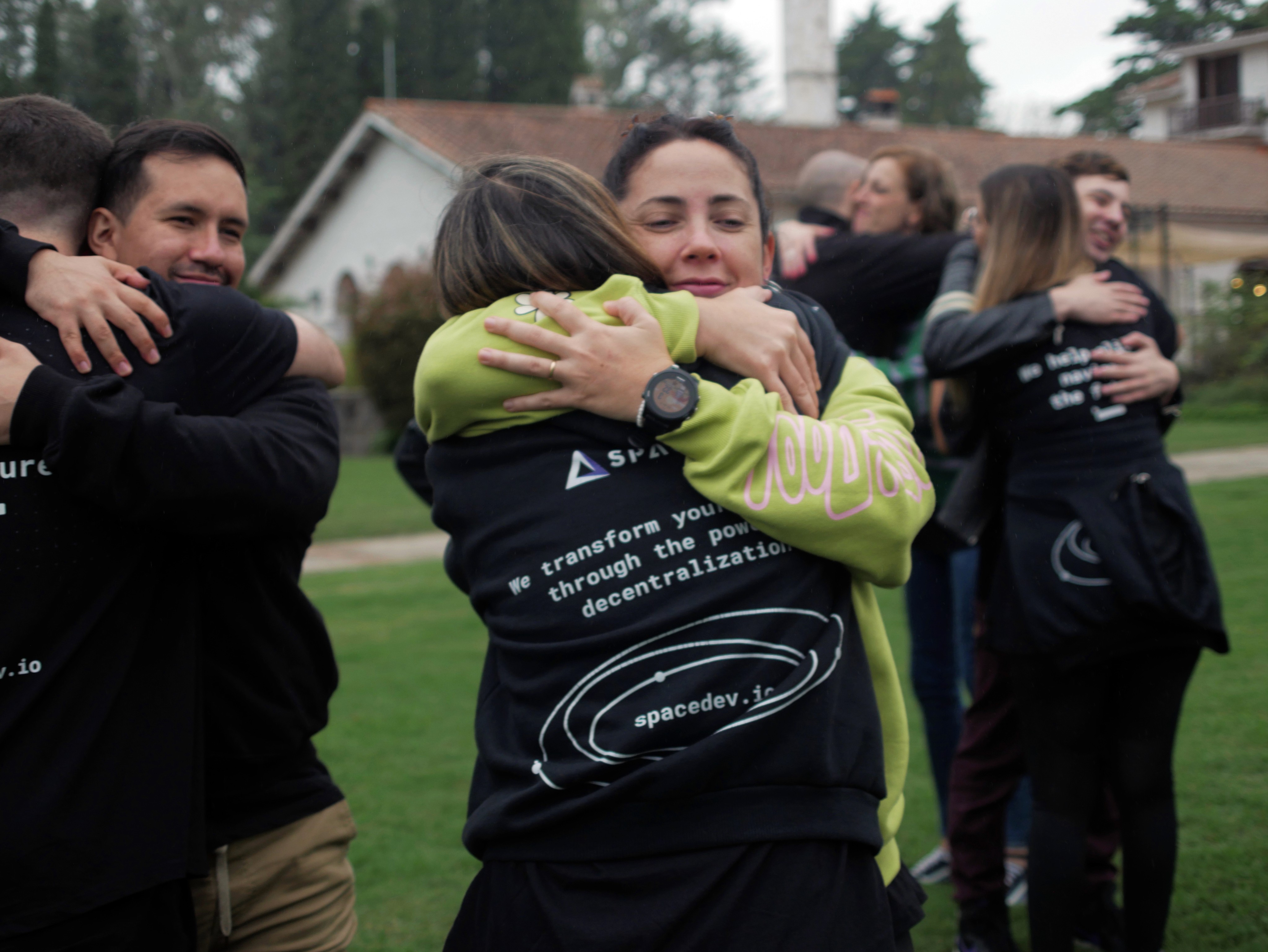 Grecia Tardaguila, Head of People, warmly embracing a teammate during an All Hands gathering.