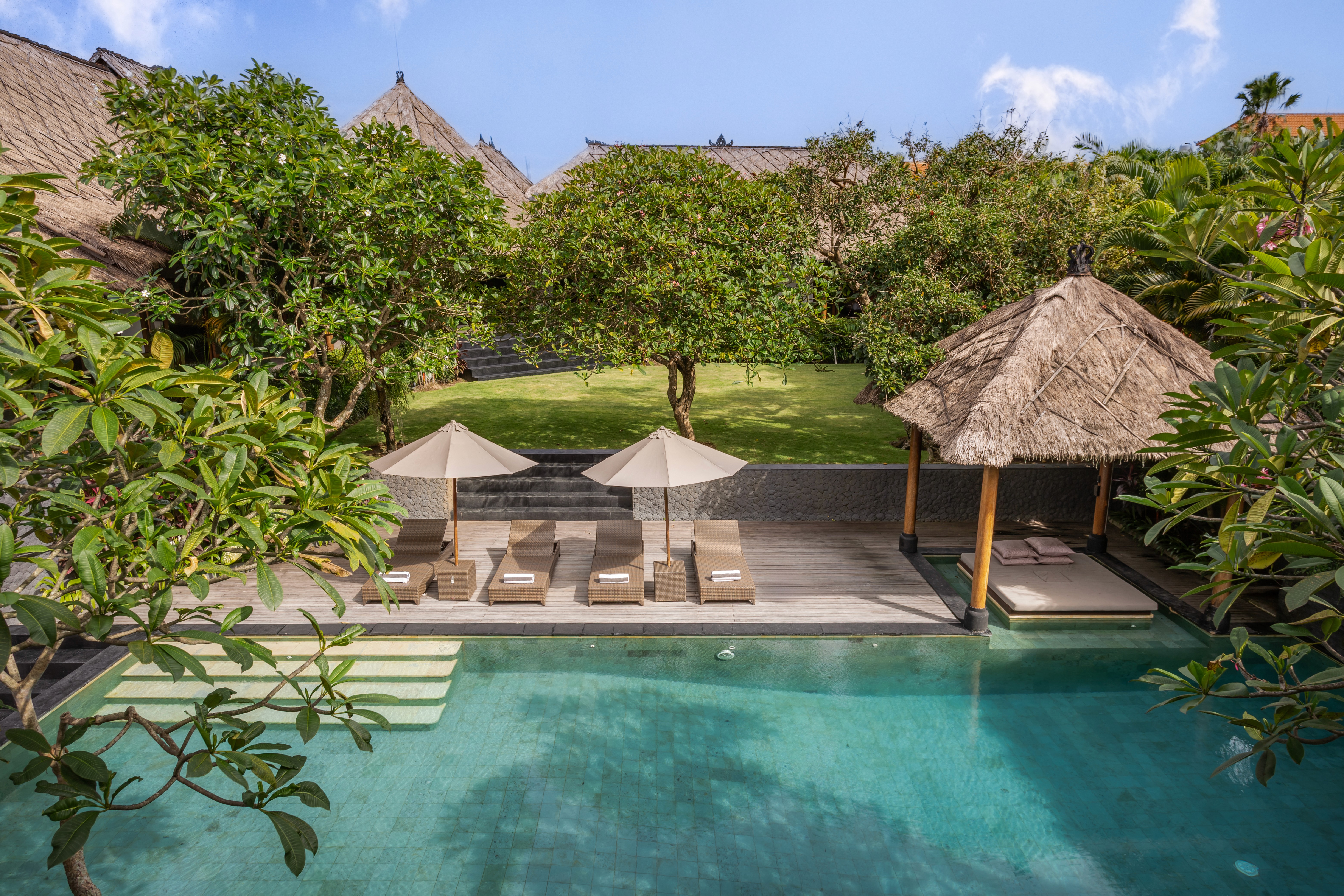 Modern hillside house with glass balcony and sloped garden beds