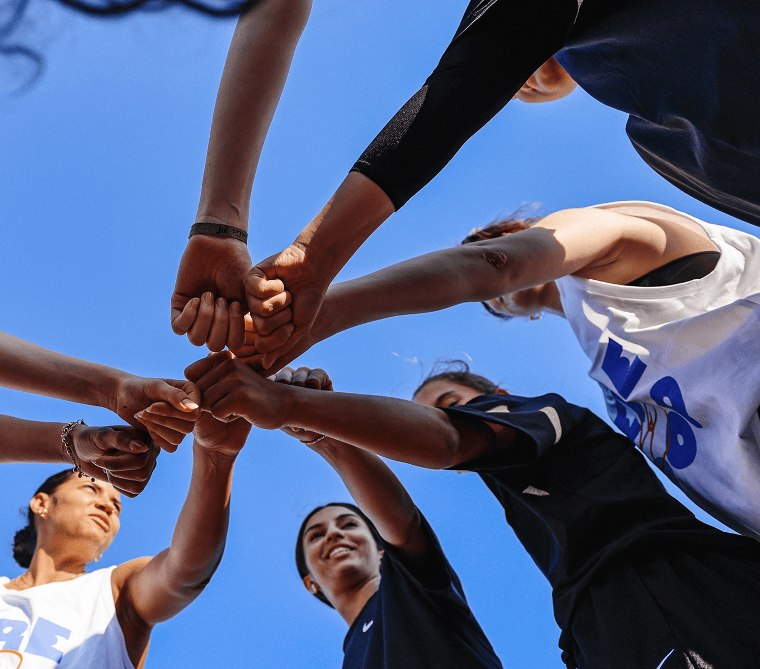 group of women in red and white dress standing on brown wooden bar during daytime