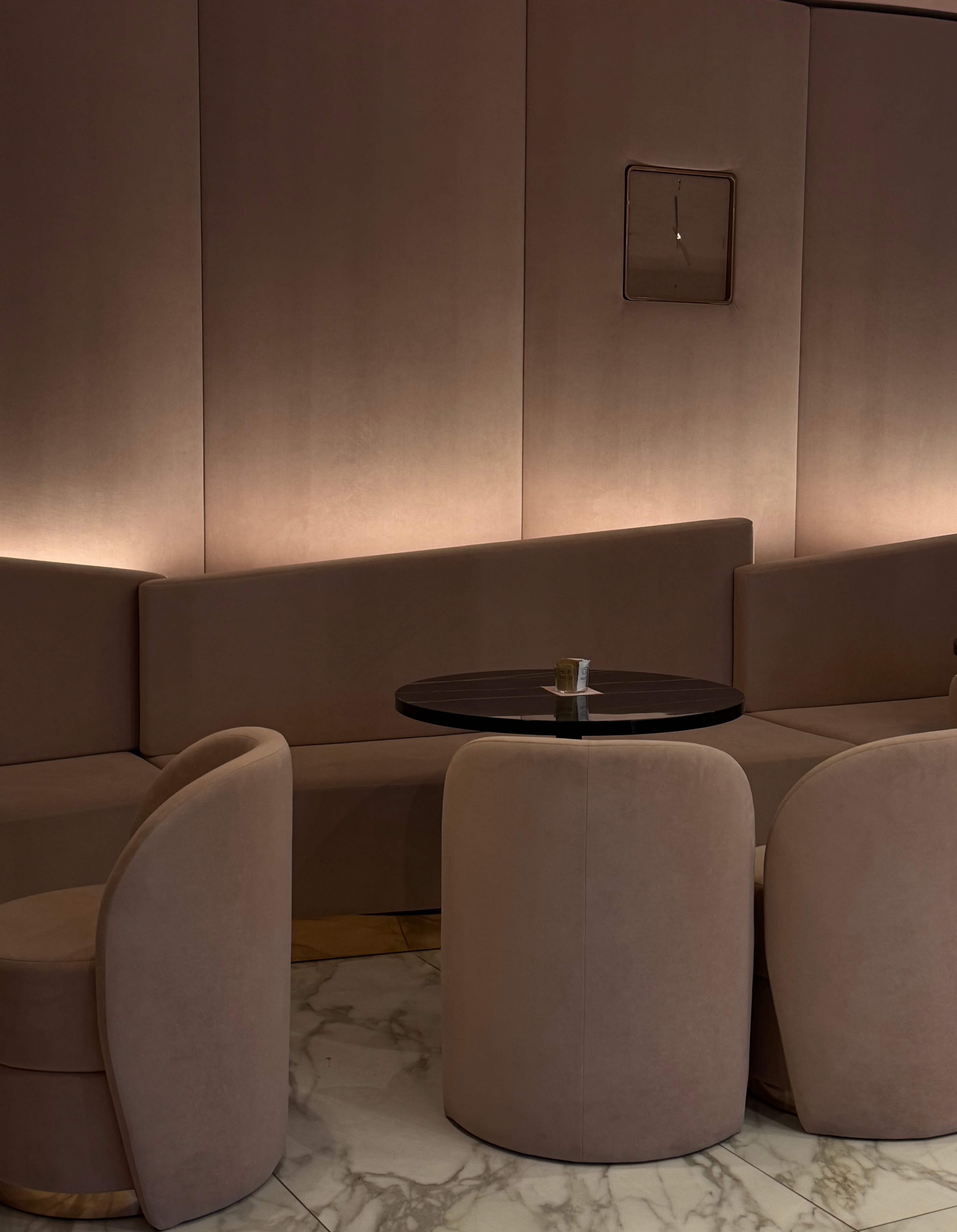 a modern restaurant banquette that's backlit to create striking warm ambiance