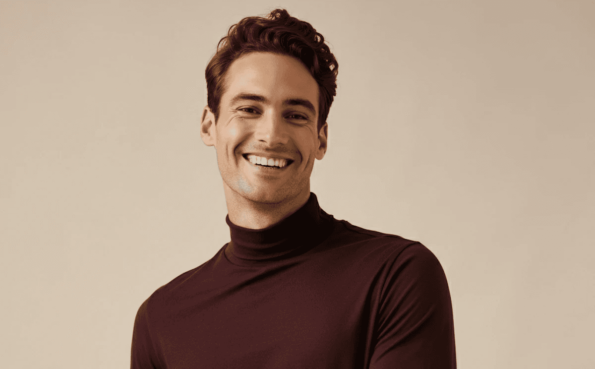 Smiling man in maroon long-sleeve turtleneck sweater