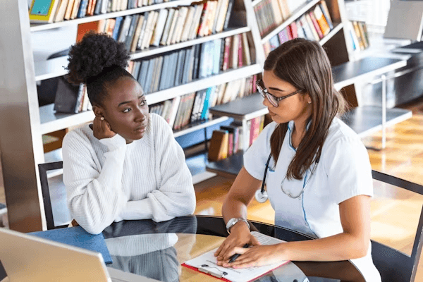 High school student conducting mental health research with a PhD mentor in a university setting