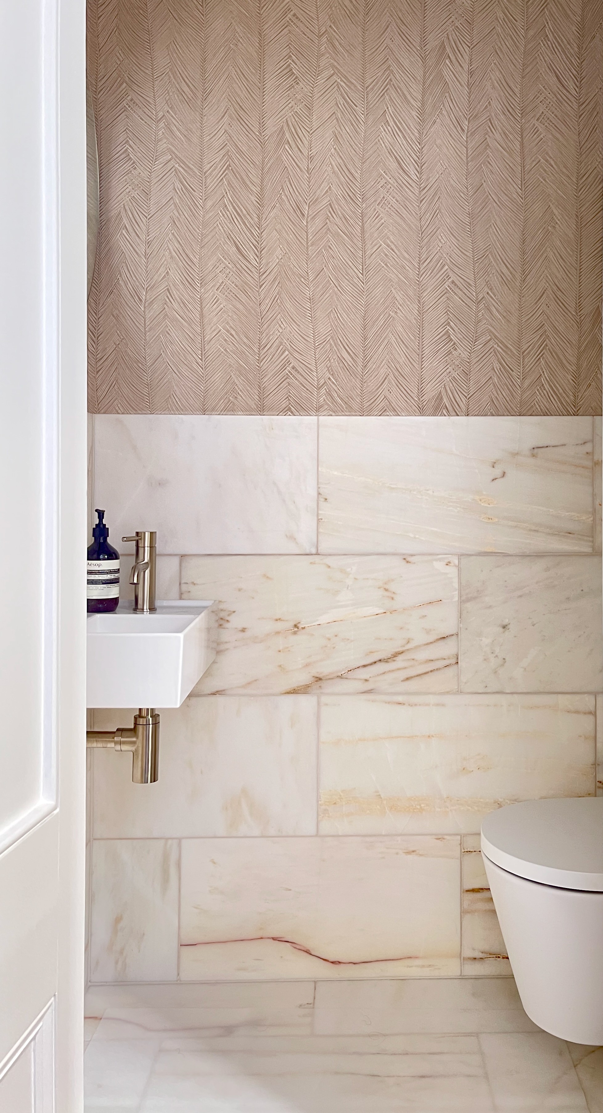 gray padded chaise couch beside window