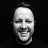 A professional headshot of a man