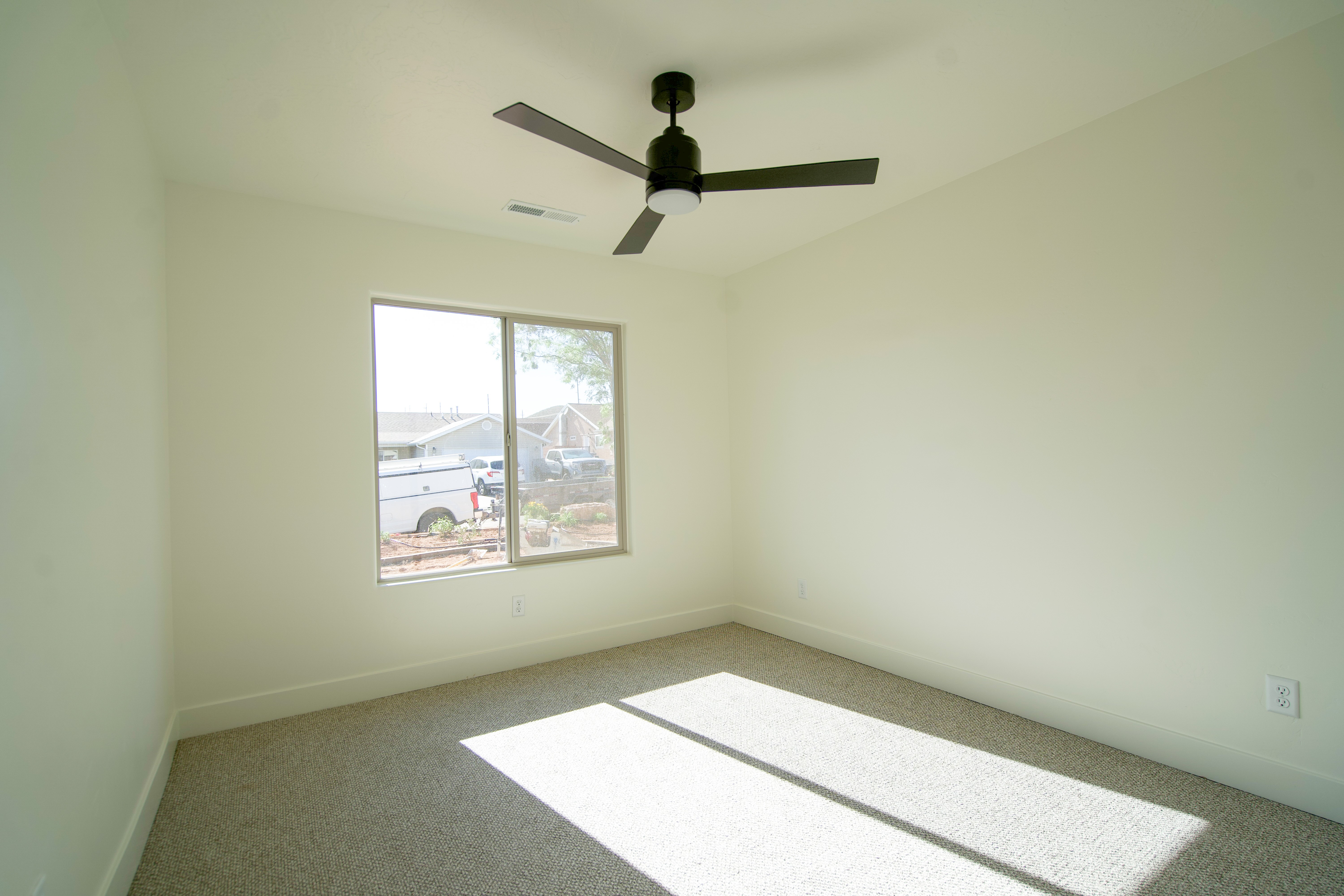 Secondary bedroom in Hurricane, Utah with simple, bright interior design.