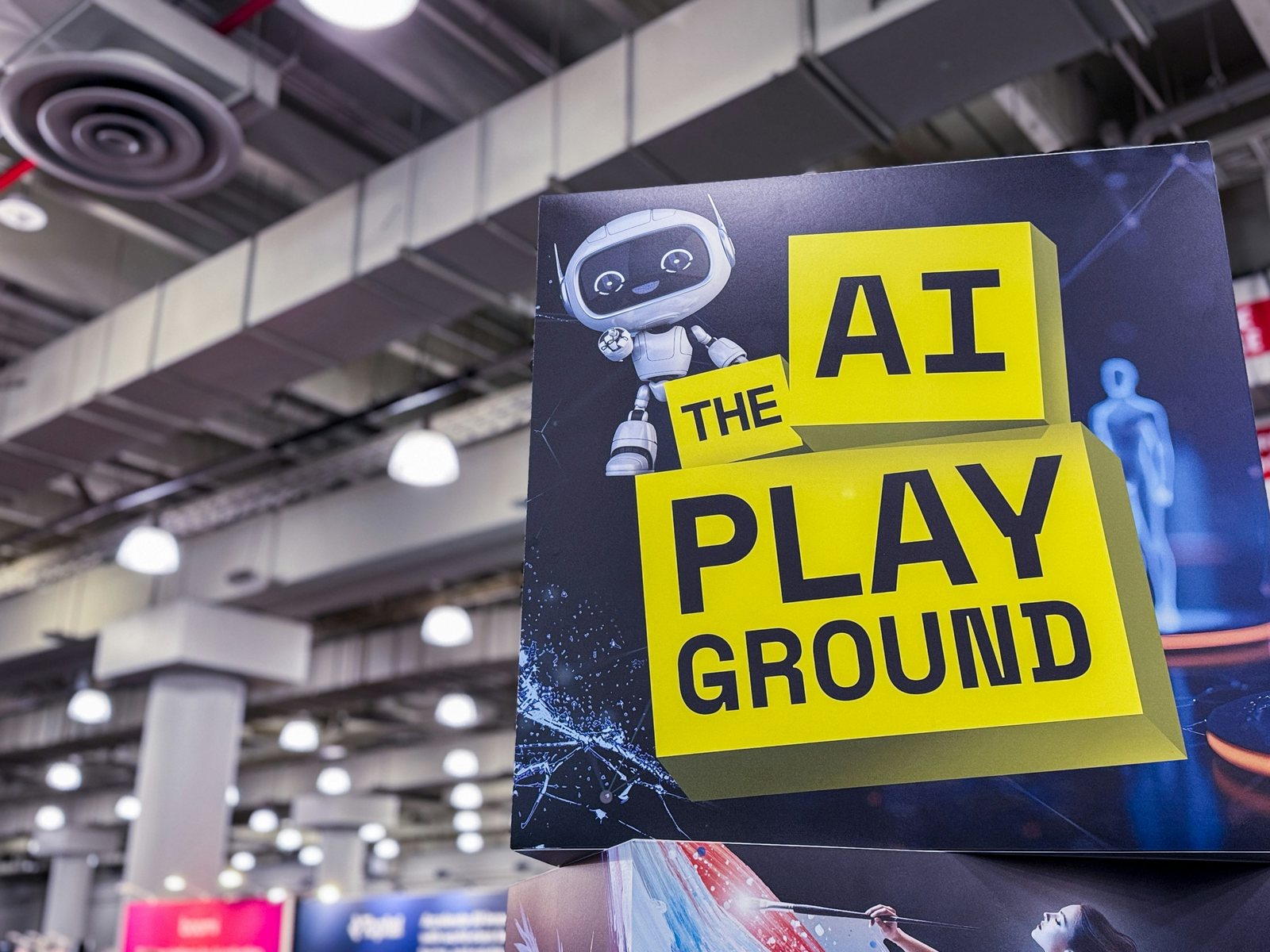 A yellow AI Playground sign hanging above the show floor at The AI Summit New York