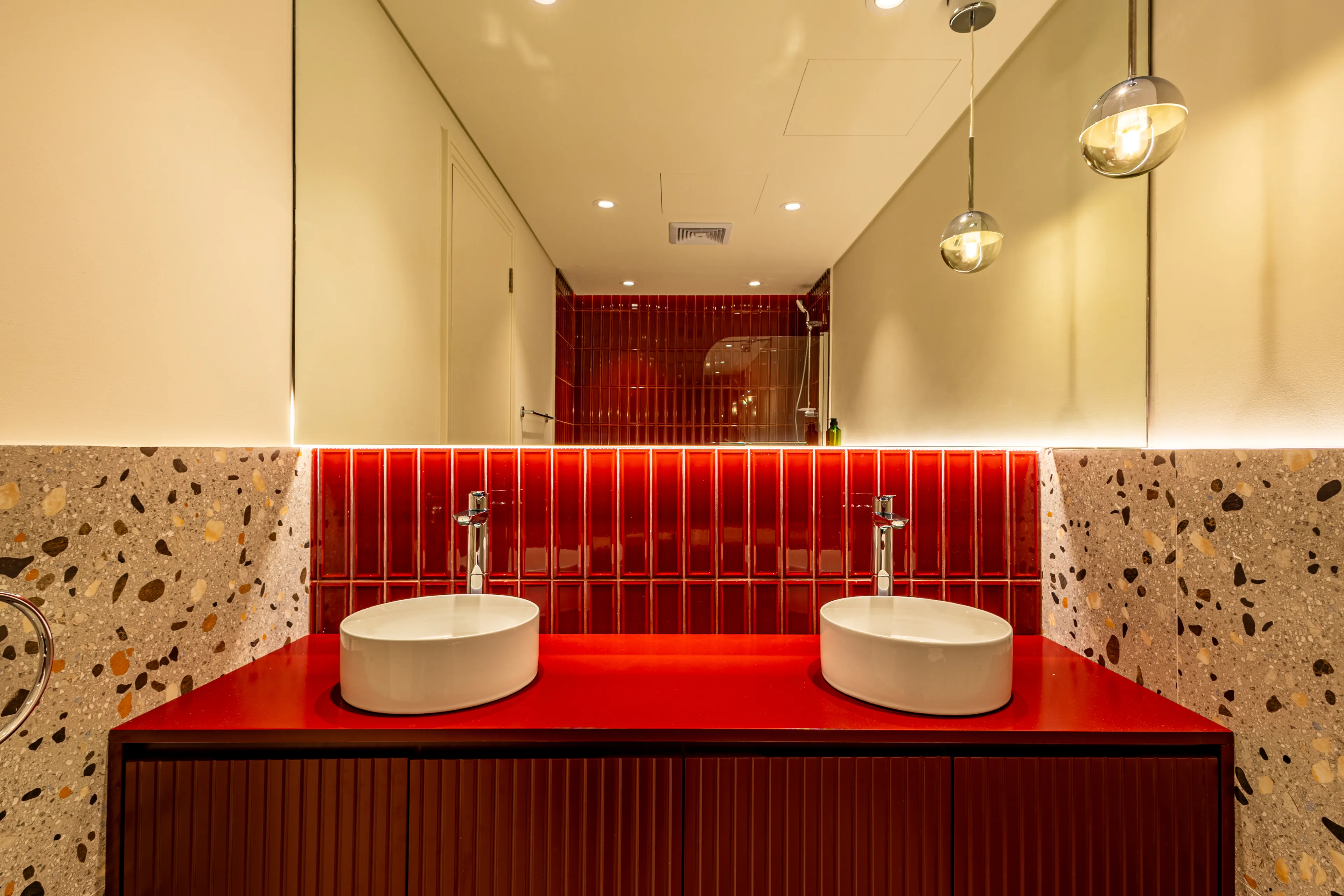 A horizontal image of red accent in bathroom.