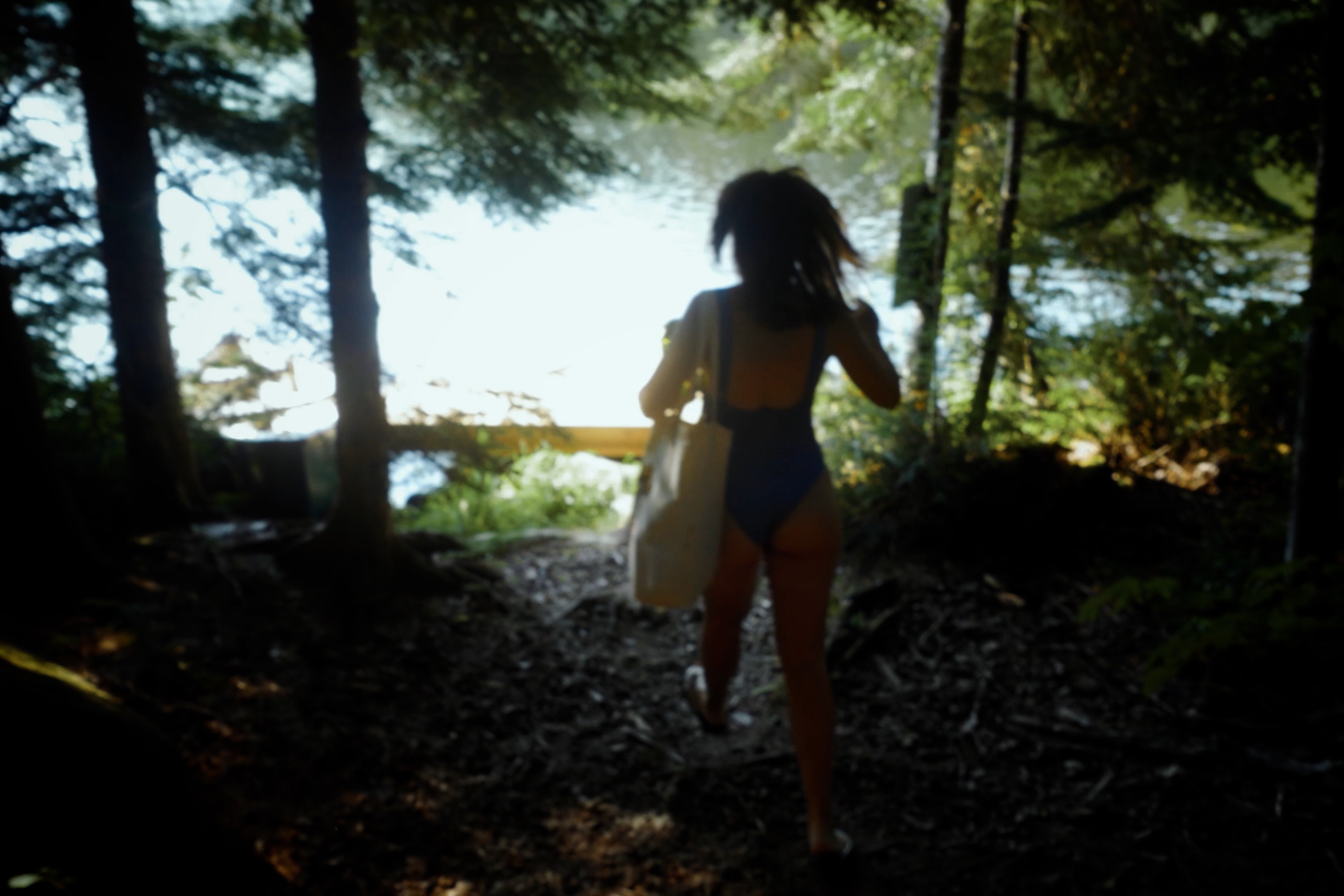 Cinematic visual storytelling film of a woman walking in the forest for La vie au lac creative video in Laurentides, Quebec