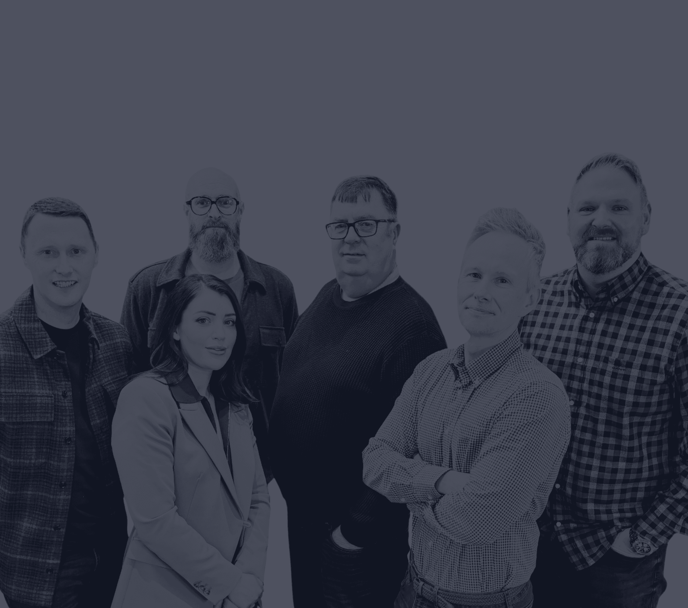 Three people sitting on a couch in a room looking at mobile devices