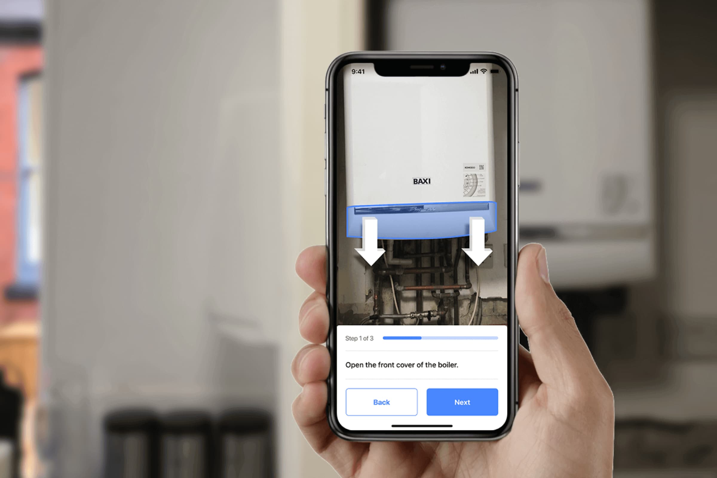 A hand holding an iphone showing an AR application, scanning a boiler in the background