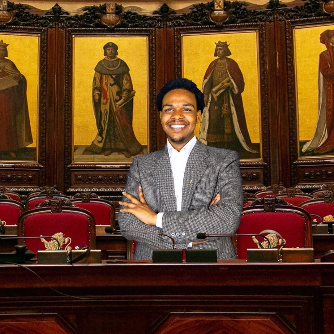 Close-up of lush, dark green leaves, some glossy and wet, against a muted background.
