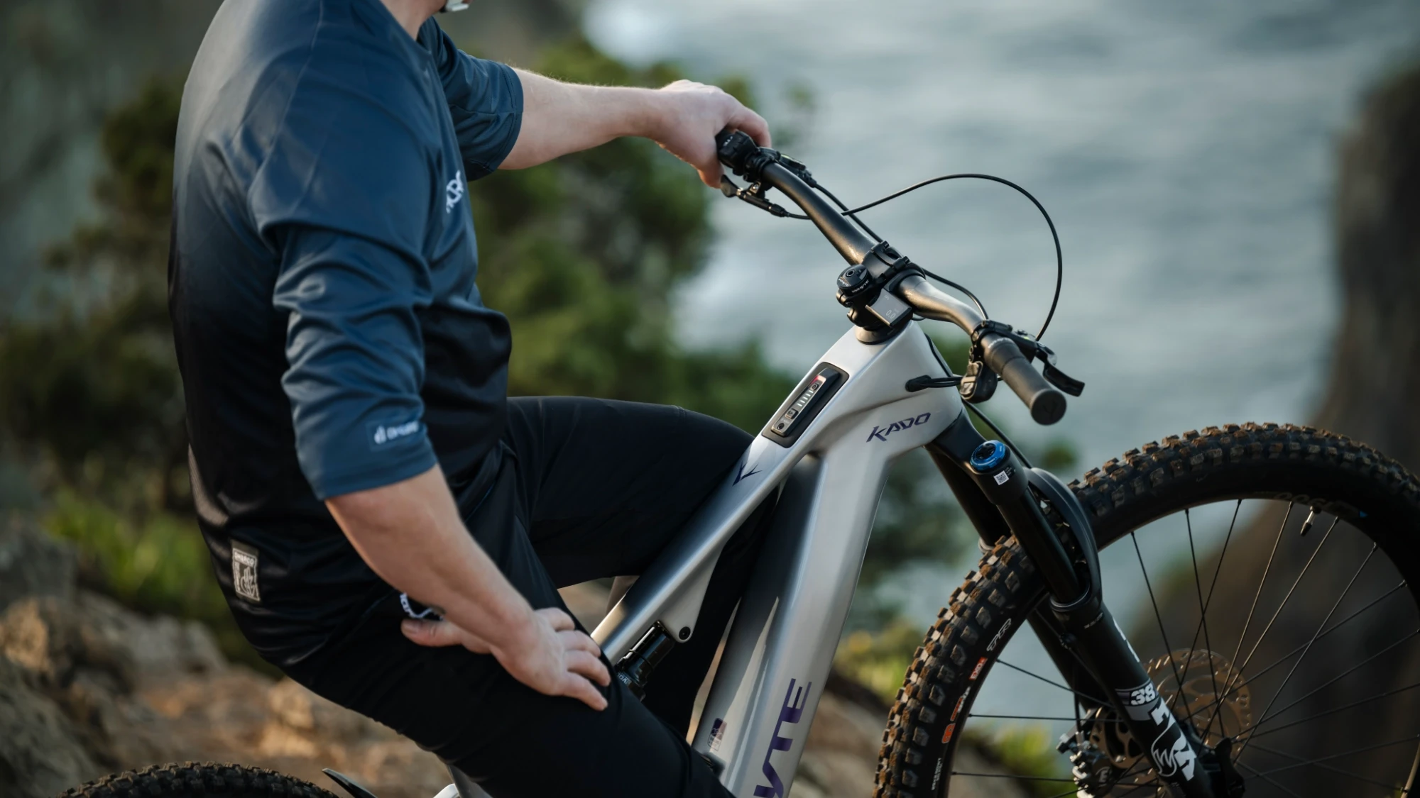 Rider using the Whyte Kado electric bike, showcasing the frame design, integrated battery system, and overall product aesthetics.
