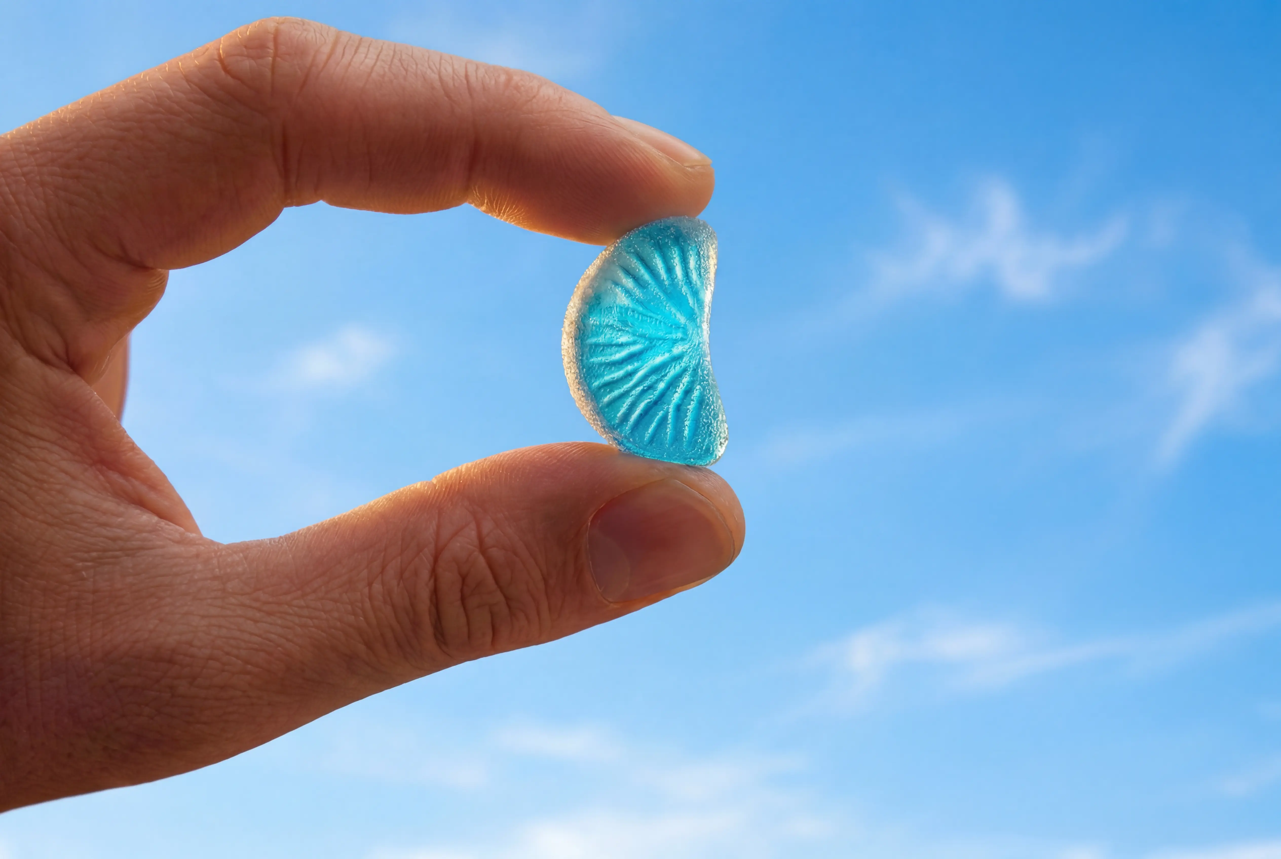 Holding a supplement gummy in the air