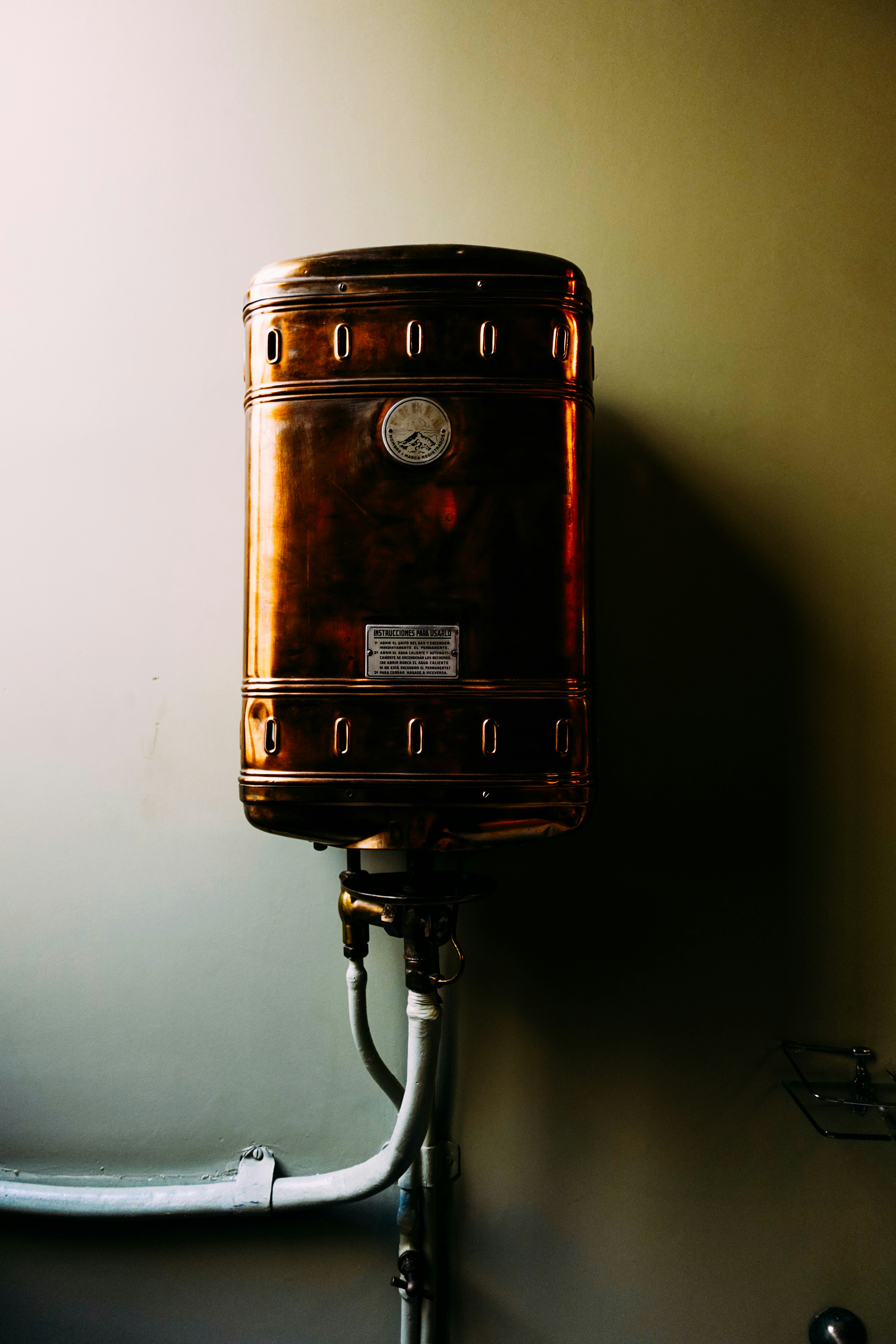 a brown suitcase sitting on top of a metal pole