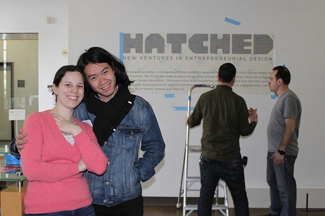 A photo of a group of people imprinting on a wall the text Hatched along with other useful information.