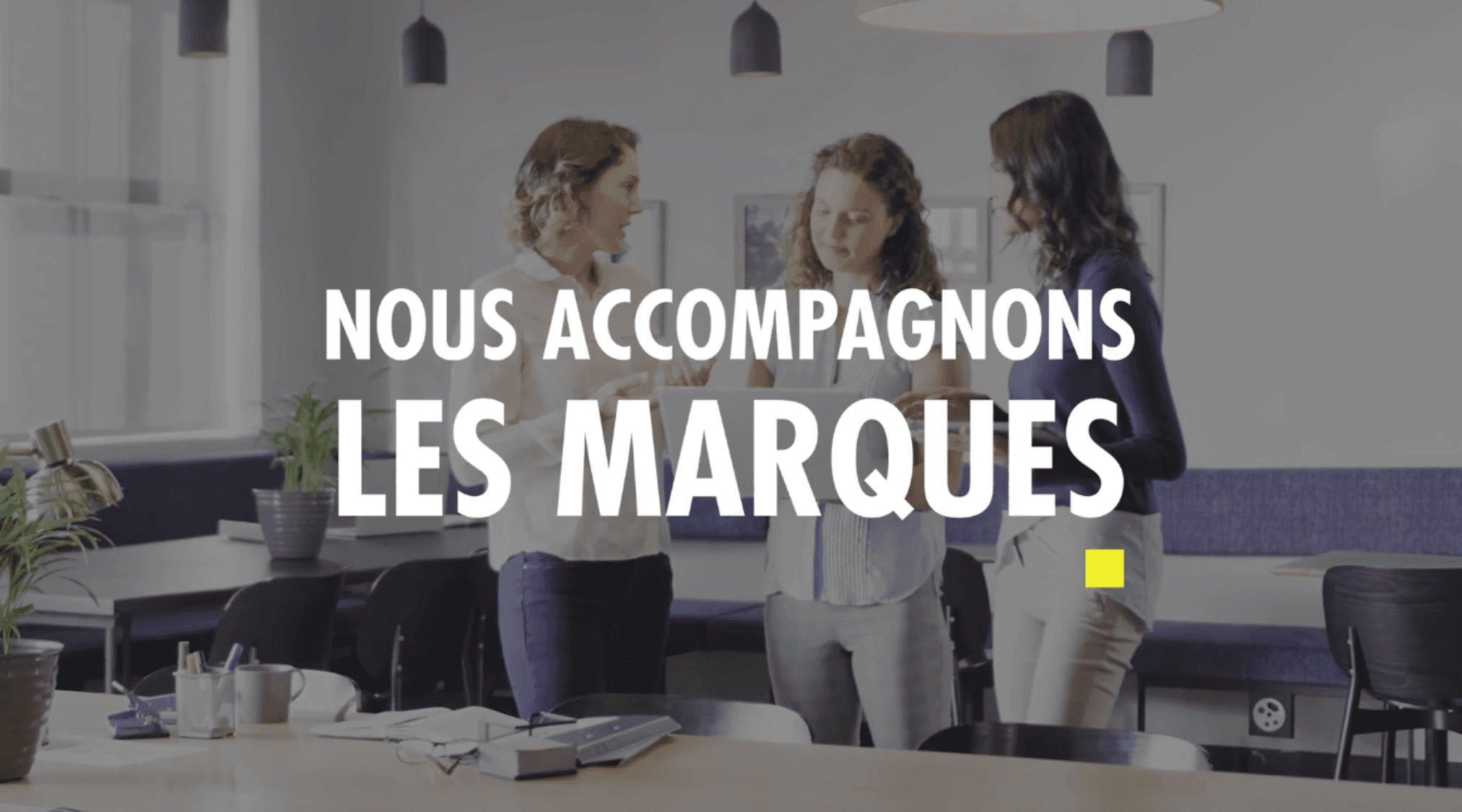 Two men in dress shirts stand against a striped background. One adjusts his tie, both look thoughtful and focused, conveying a professional tone.