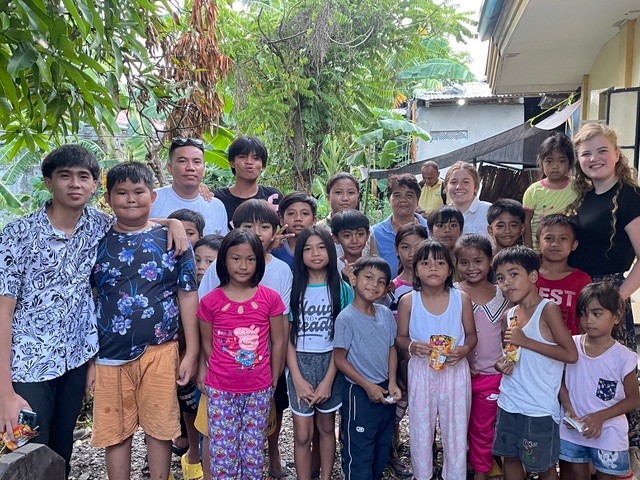 Group photo of Claire with kids