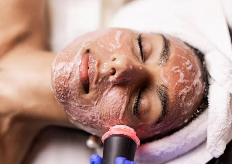 A woman getting a Glo2Facial at a spa.
