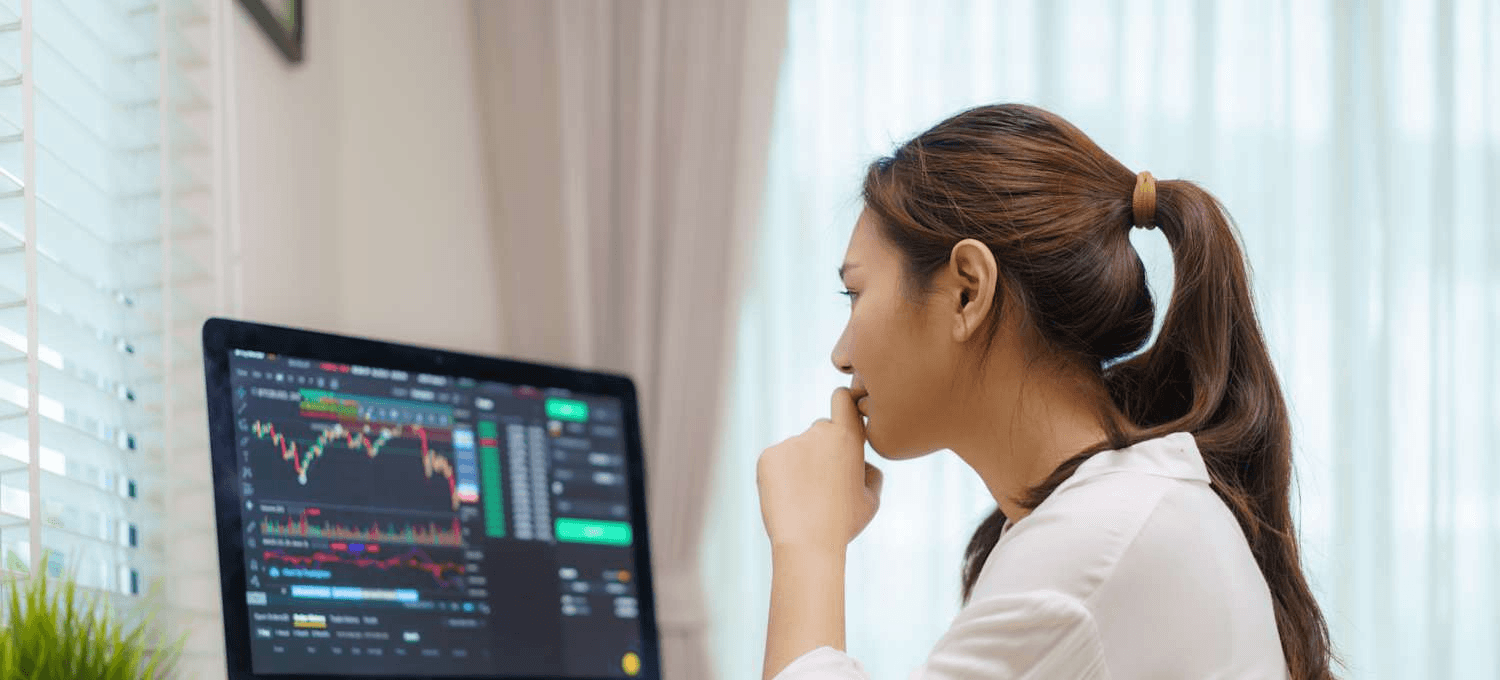 Woman analyzing financial market data on computer - BullX Alternative