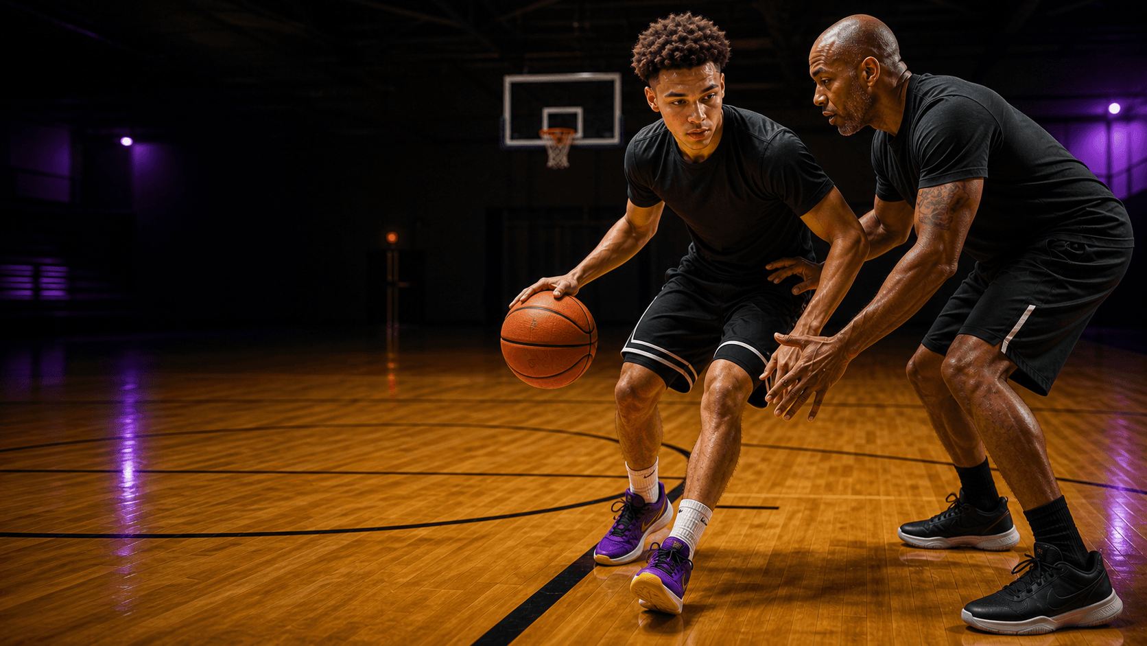 Basketball coach teaching a guard a footwork detail on court