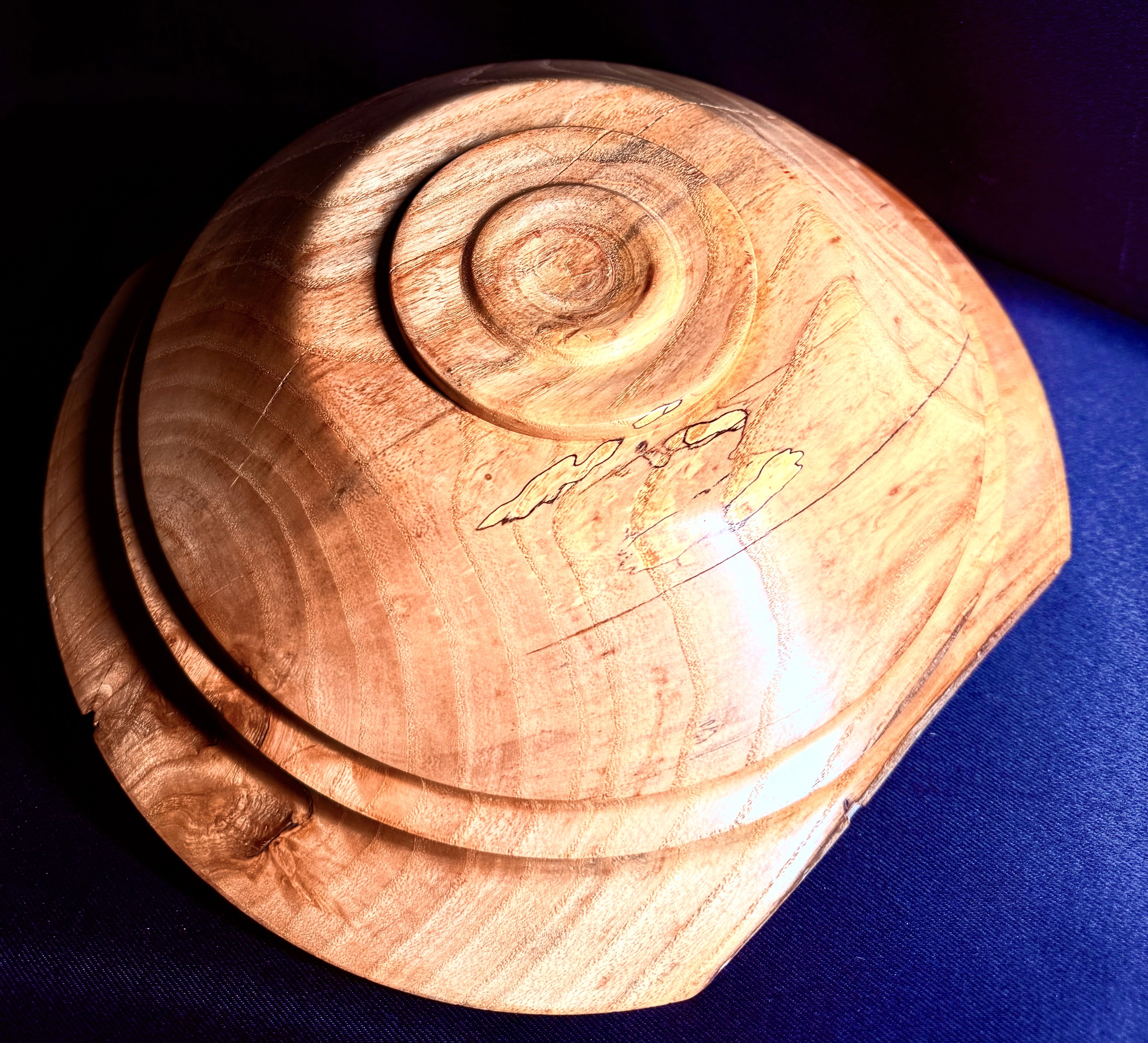 Detail of the ash grain, spalting, and filled checks on the asymmetric bowl.