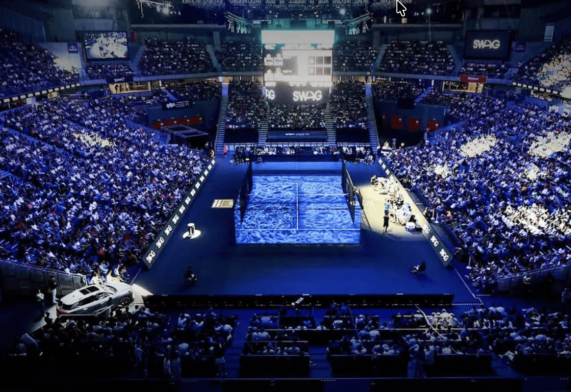 Palm trees frame a dramatic mountain valley landscape