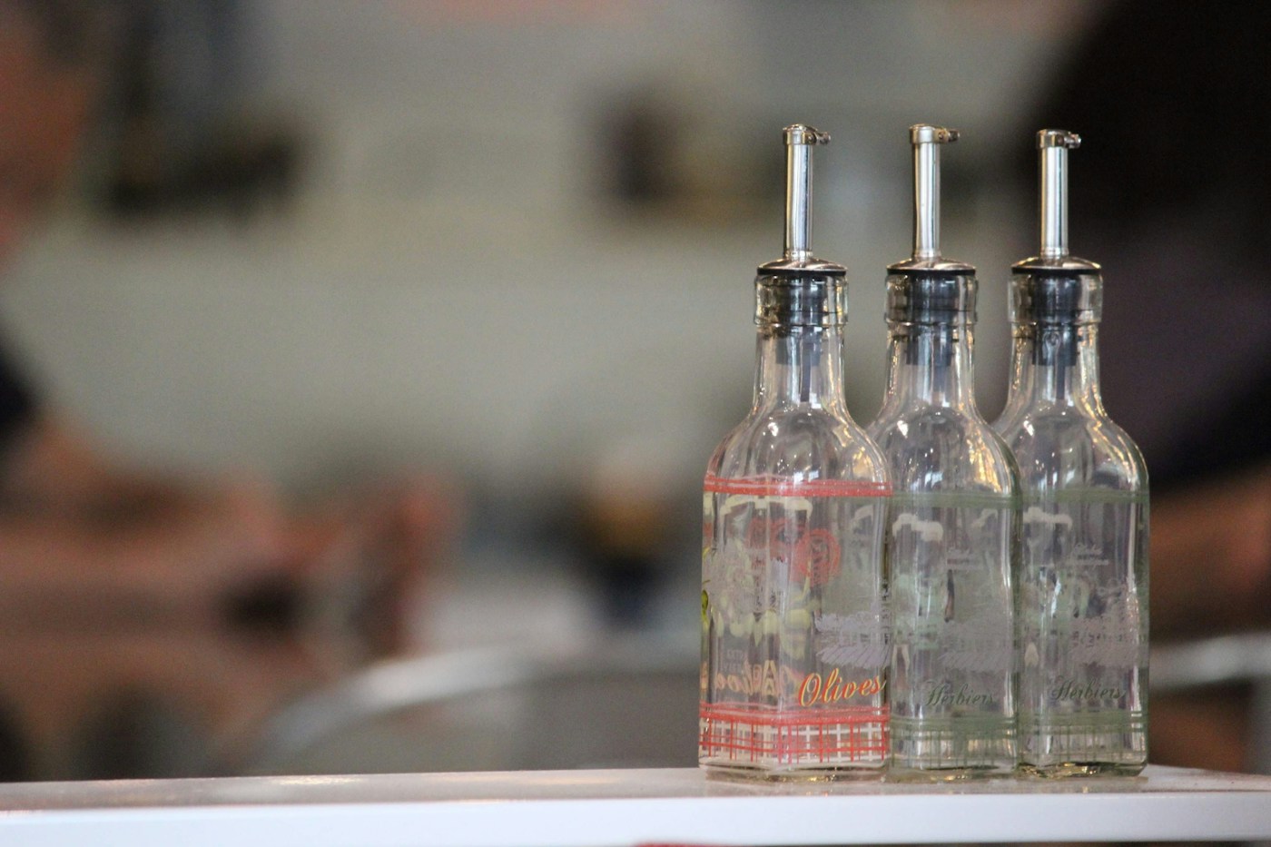 Three glass bottles with pour spouts