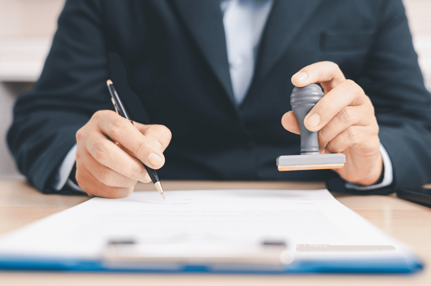 Business professional stamping documents, symbolizing policy changes, tariffs, and compliance affecting Amazon advertising costs.