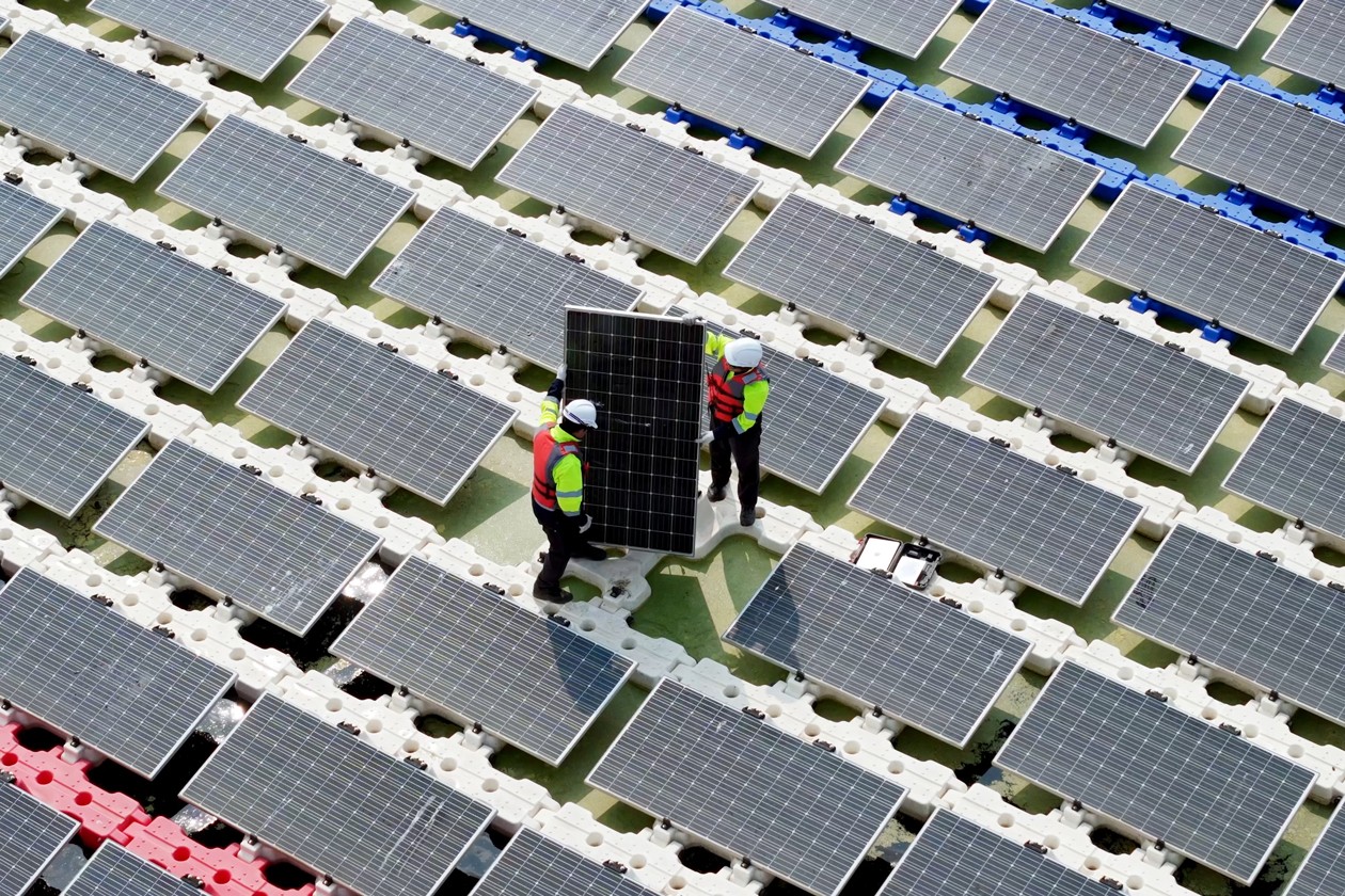 engineers working on a solar panel