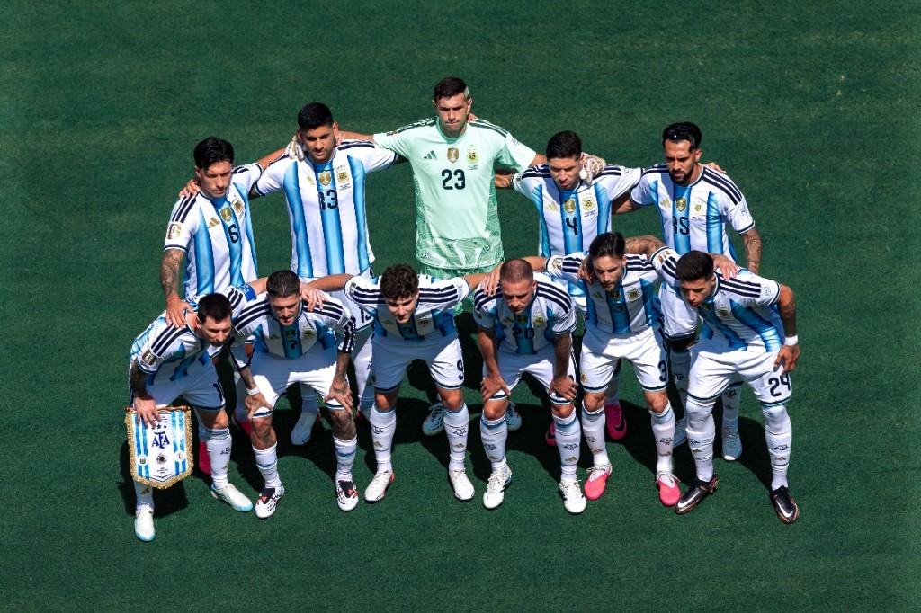 Argentina's starting lineup poses for the team photo before the 2026 FIFA World Cup final, with Lionel Messi holding the pennant