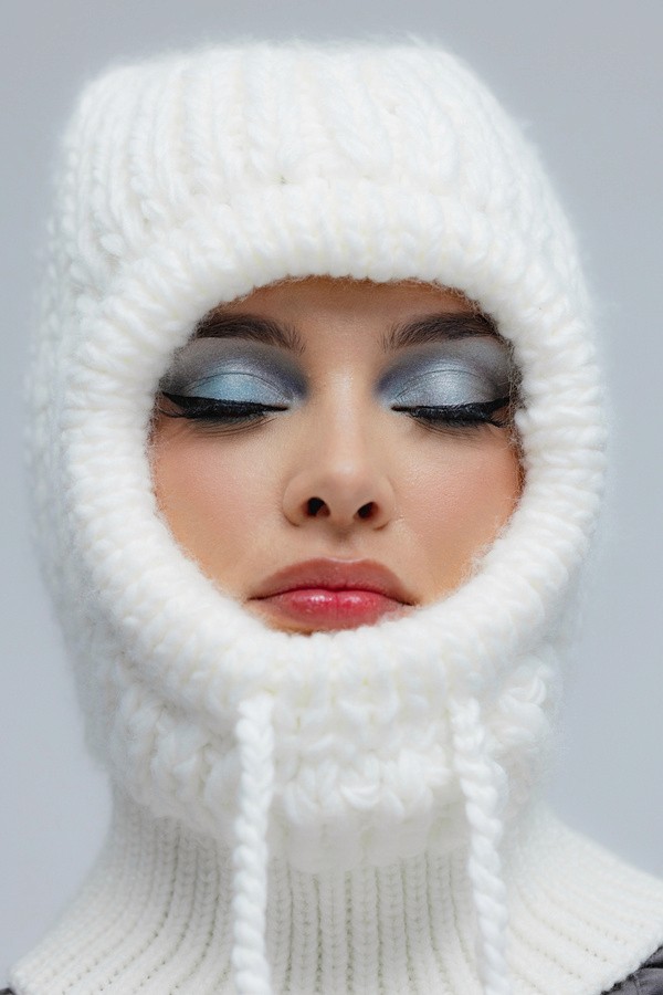 white woman in a white fur hoodie 