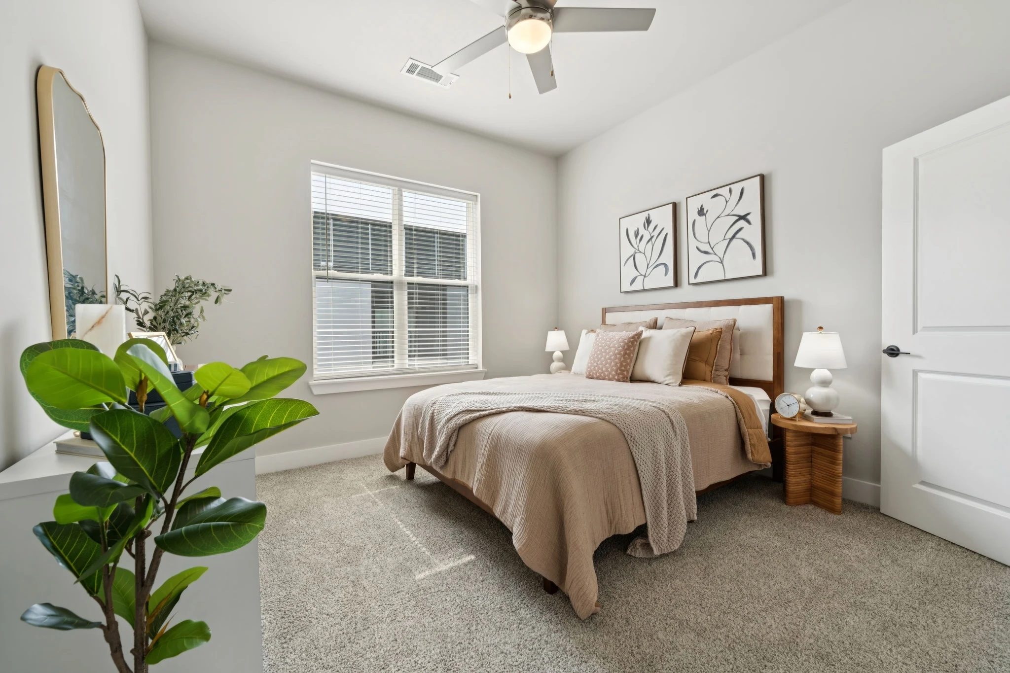 A cozy bedroom featuring a bed, a dresser, and a window allowing natural light to enter the space.